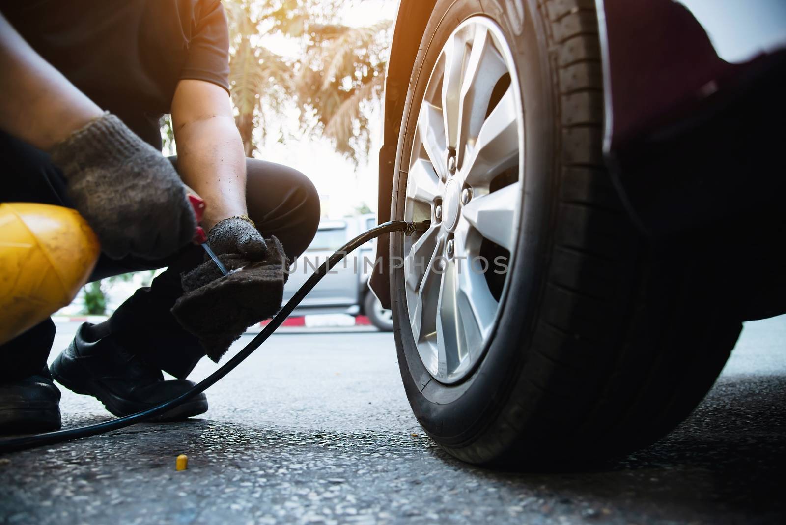 Technician is inflate car tire by pairhandmade