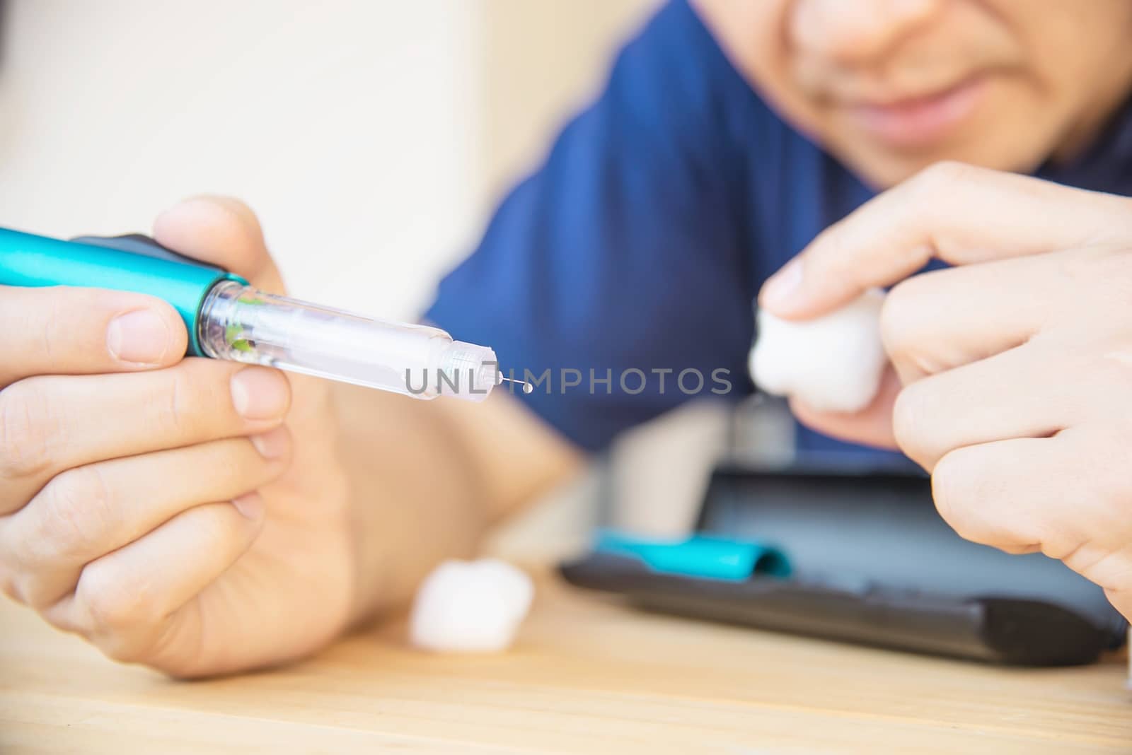 Man preparing insulin diabetic syringe for injection - people diabetic health care concept