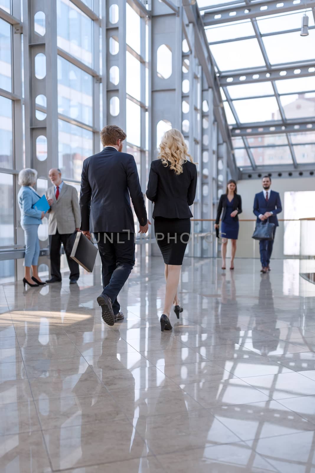 Business people walking in the lobby of a modern business center