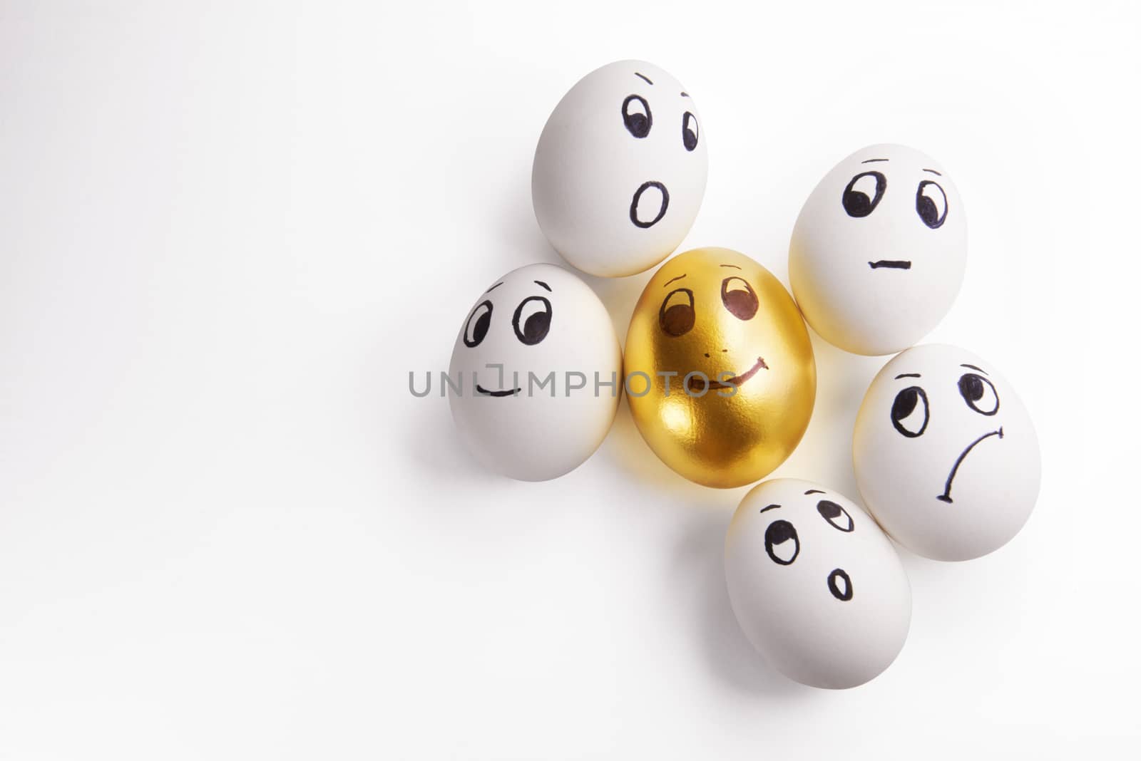 white and one Golden egg with painted faces