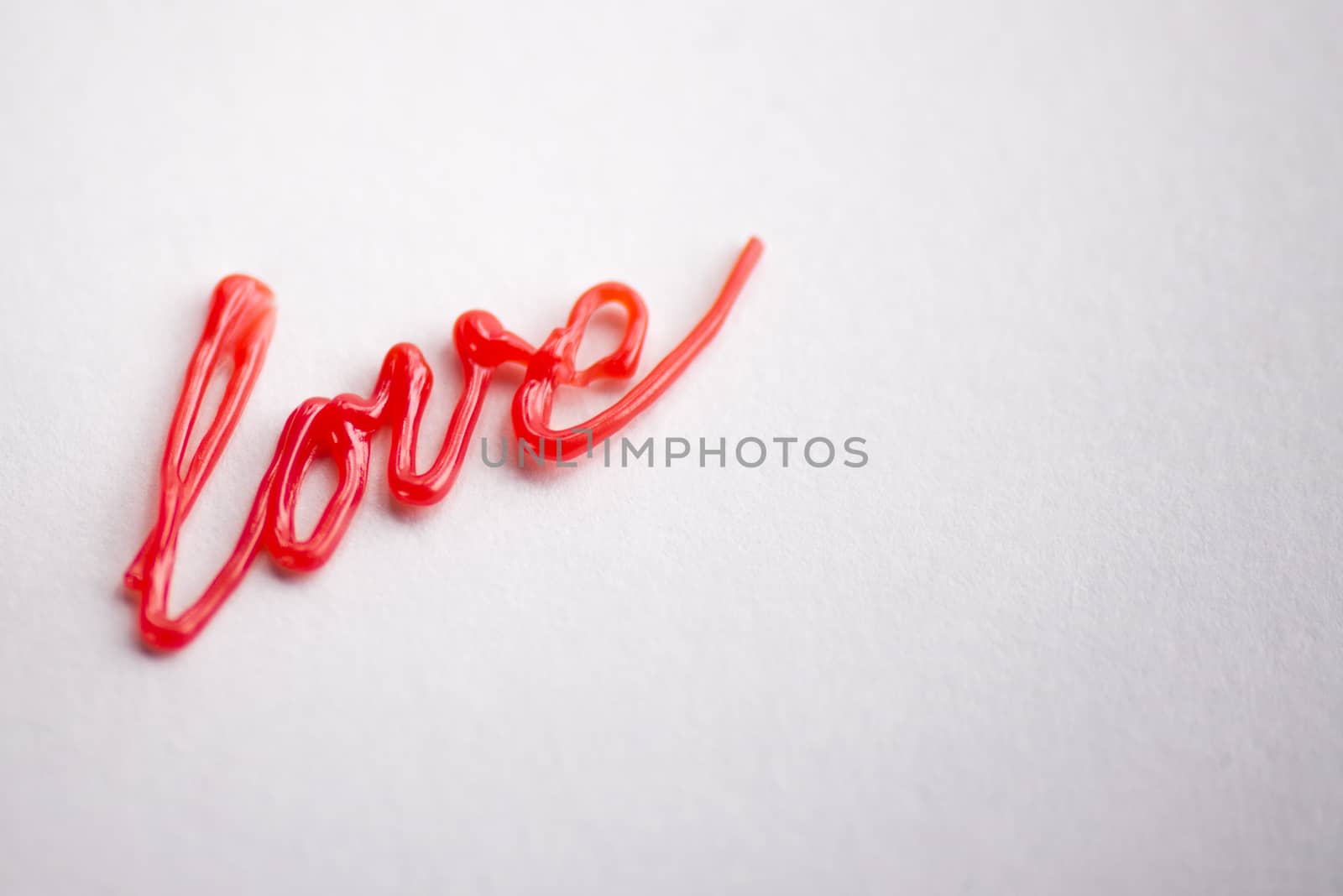 red the writing love drawn by 3d pen on white background