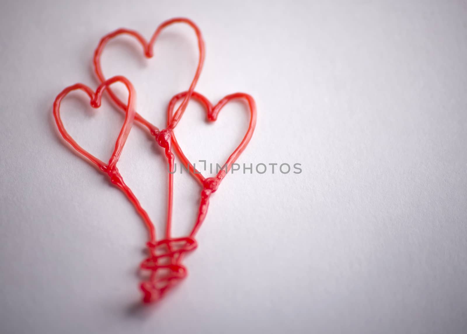 red heart drawn by 3d pen on white background