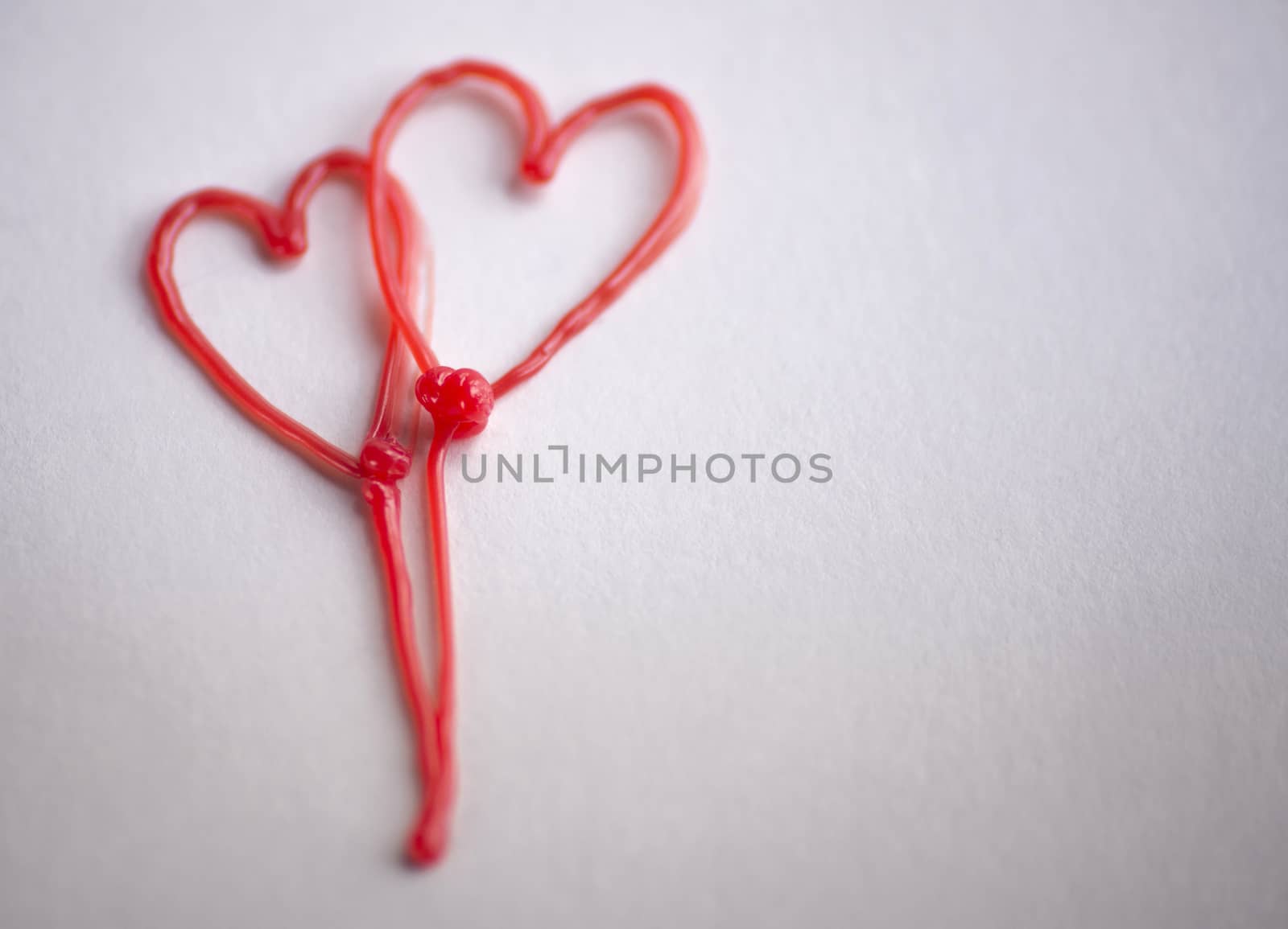 red heart drawn by 3d pen on white background