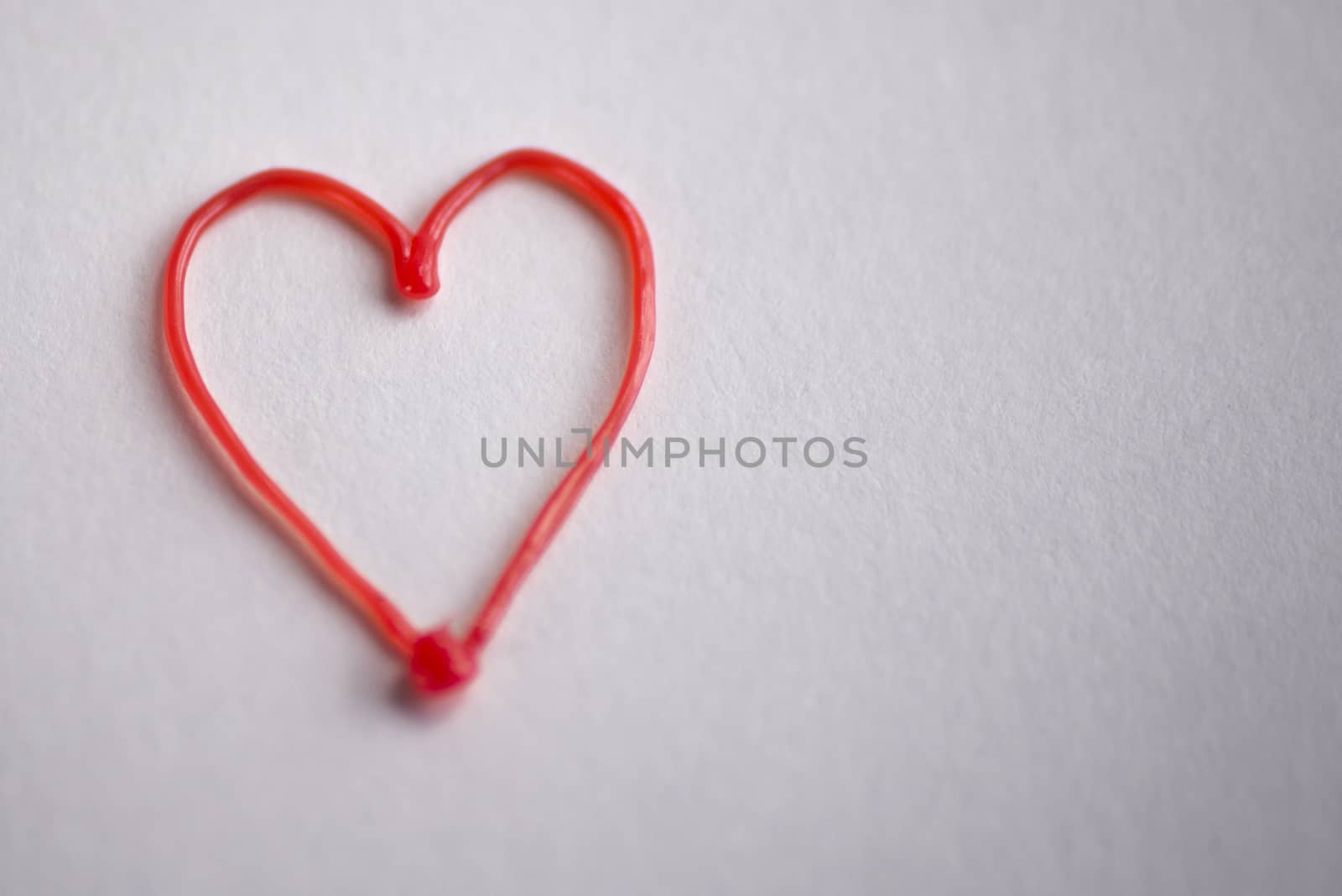 red heart drawn by 3d pen on white background