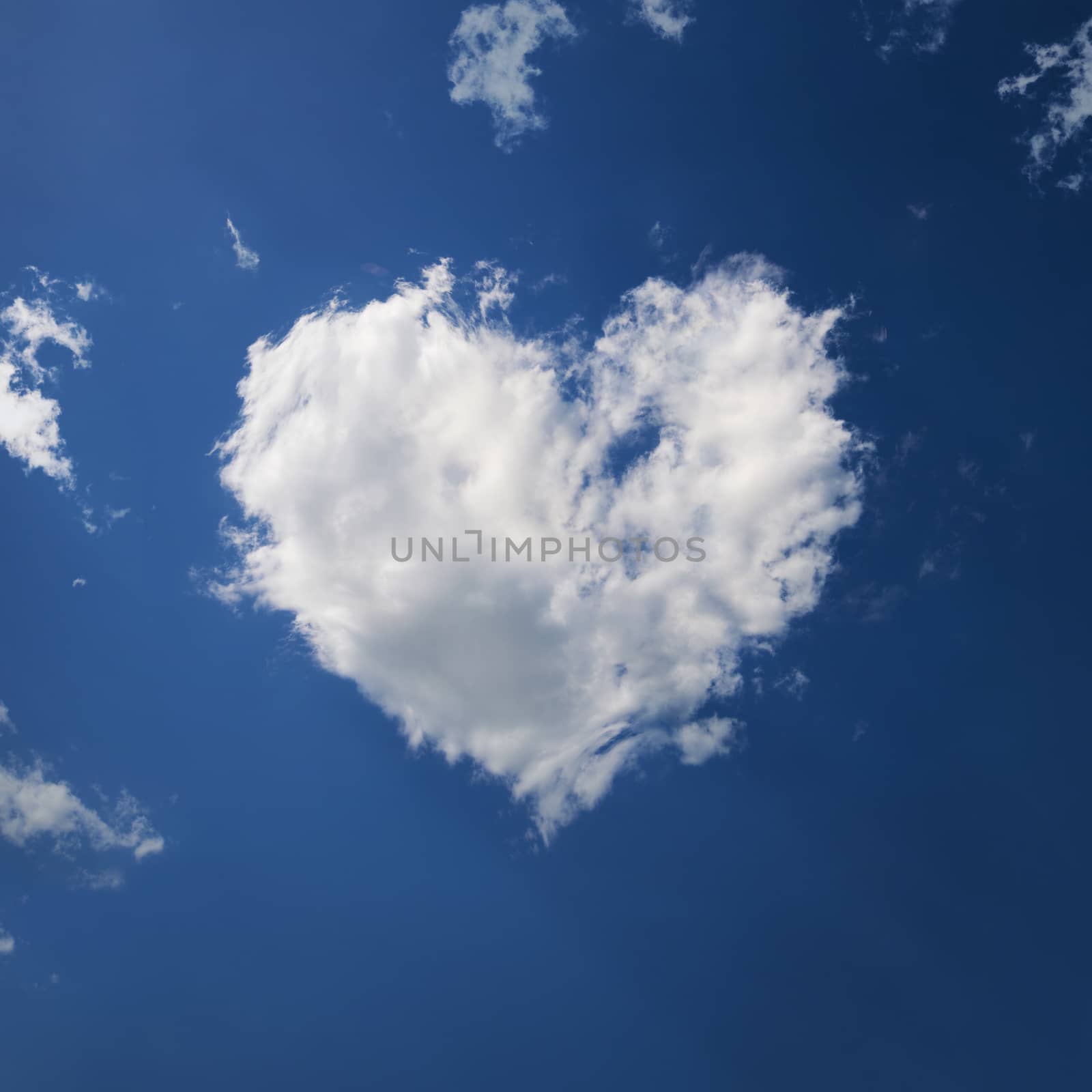 a white cloud in the shape of a heart on a blue sky