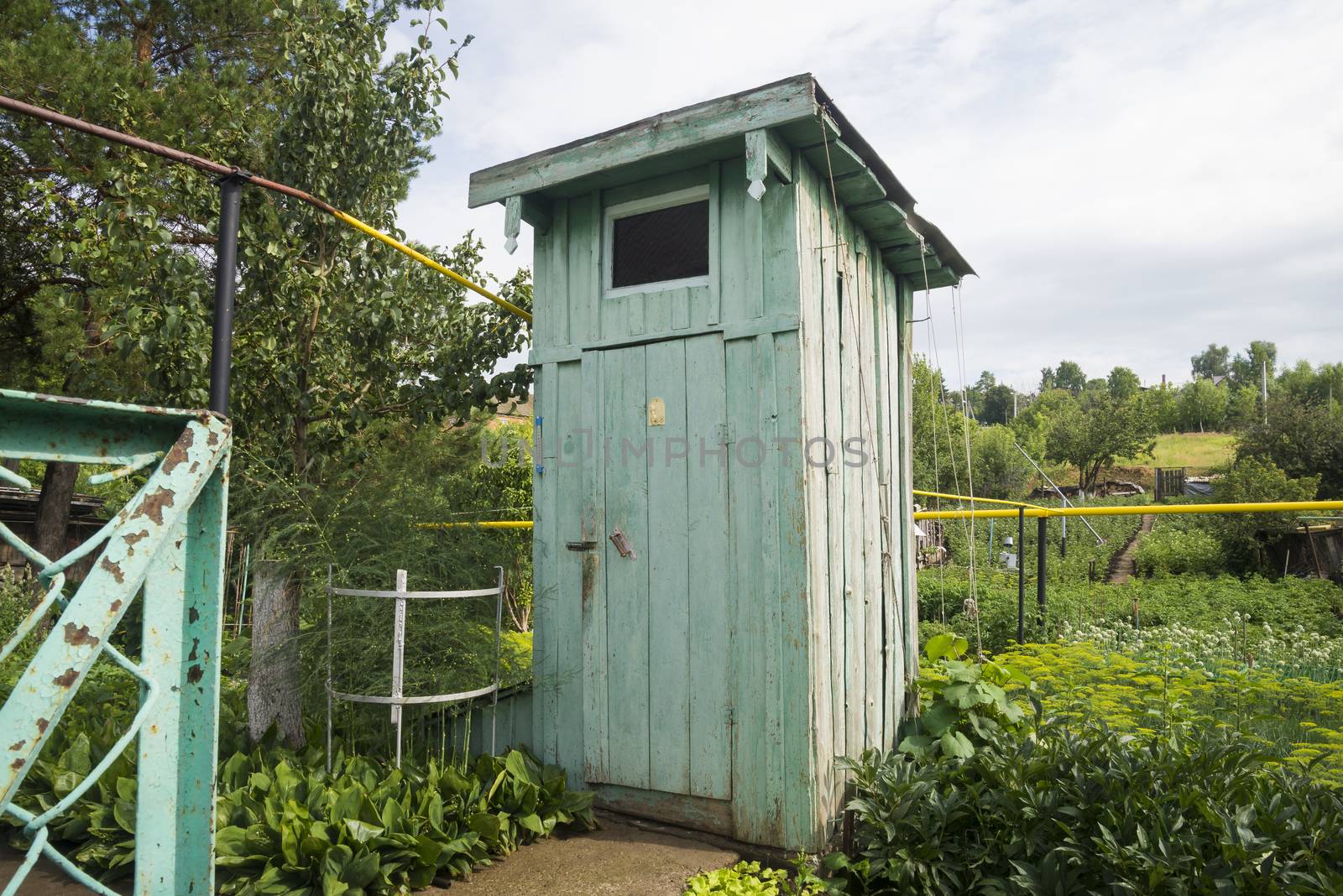 Rustic old wooden rural outside toilet outdoors on nature background