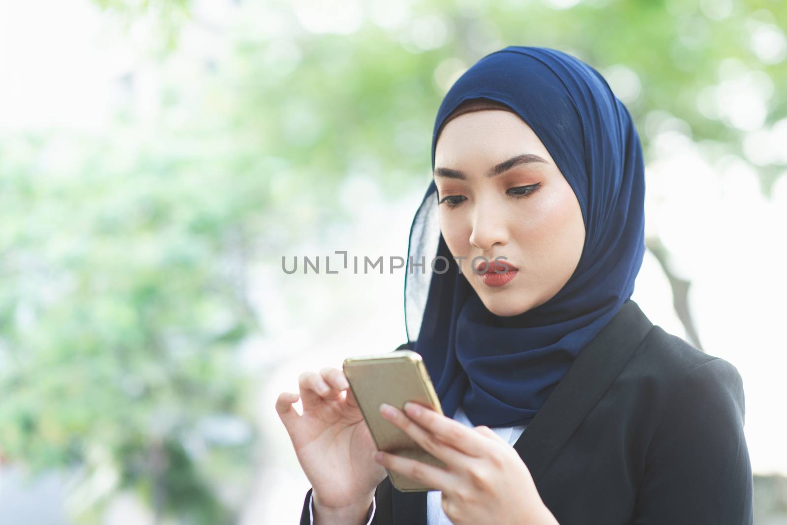 Woman looking at mobile phone with serious face, negative emotion, phishing scams concept.