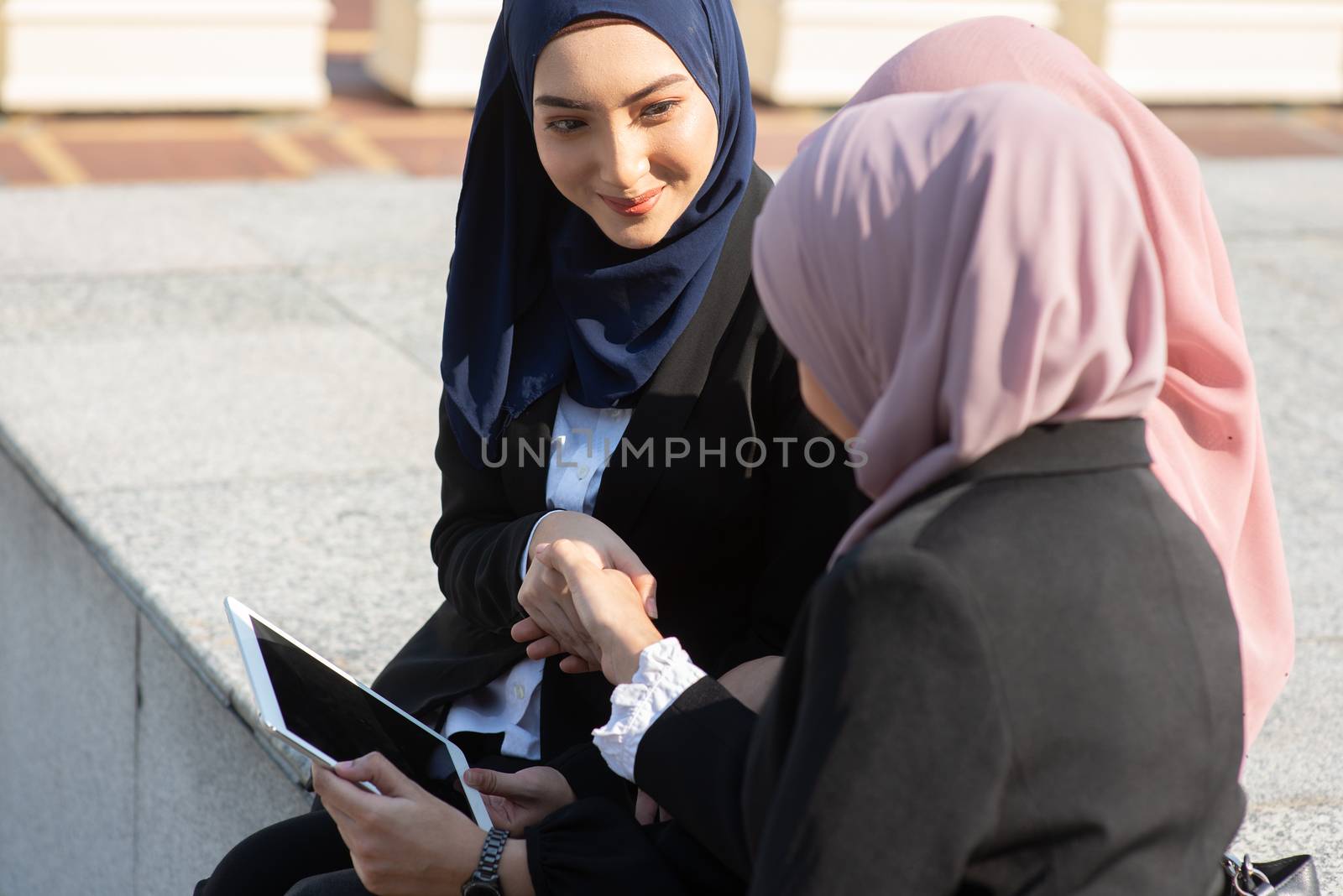 Muslim business women discussing and handshake by szefei