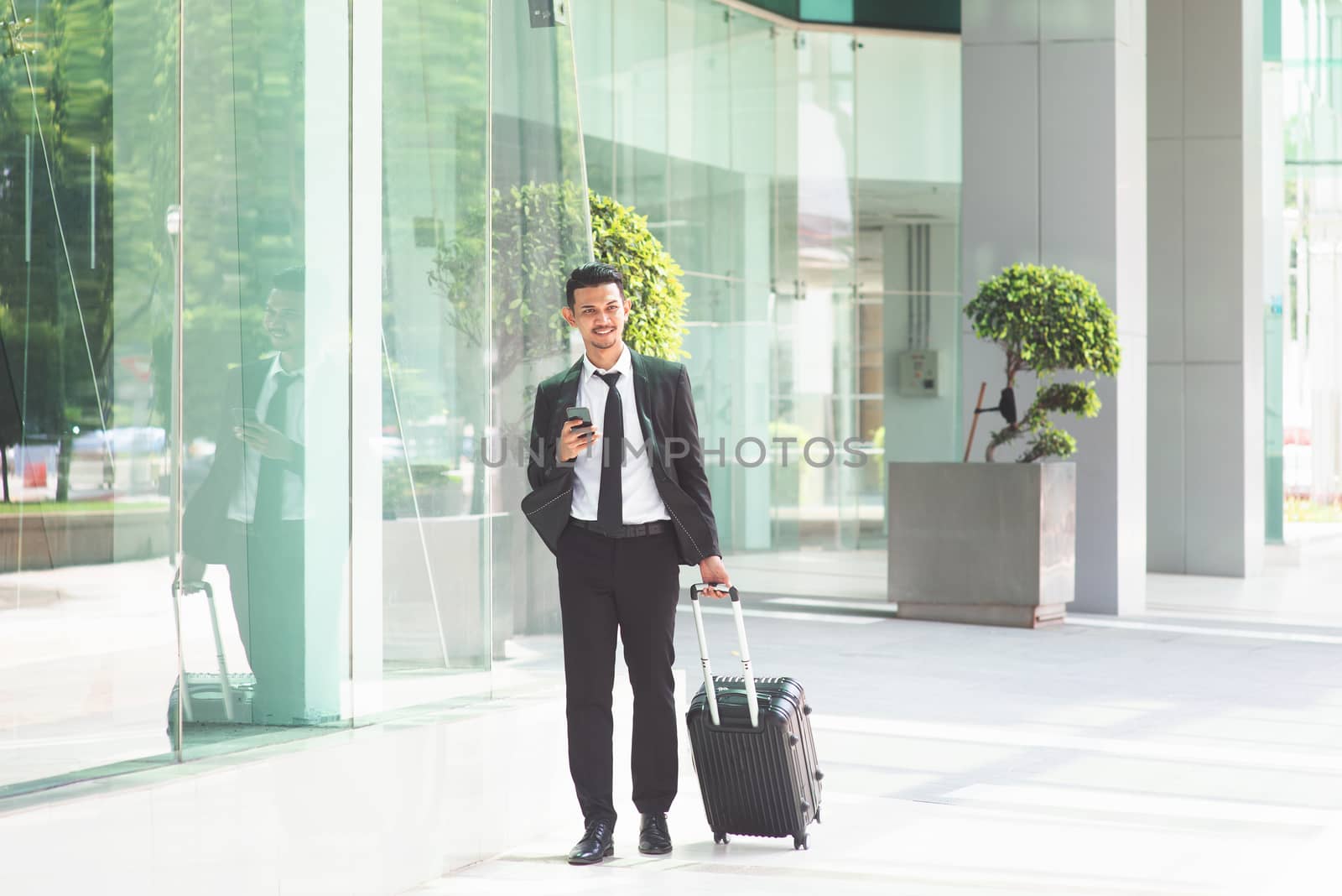 Businessman with luggage walking to airport by szefei