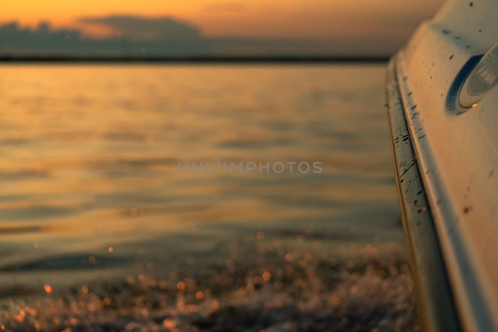 Splashes of water from the boat at sunset