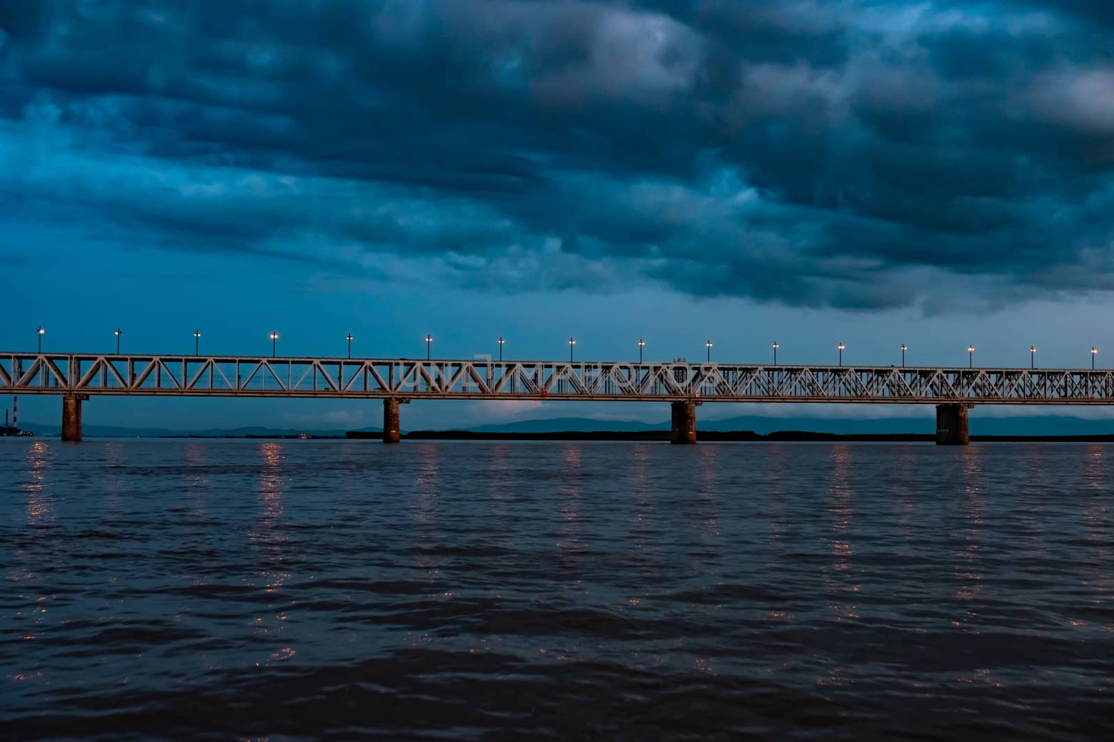 Bridge over the Amur river at sunset. Russia. Khabarovsk. Photo from the middle of the river