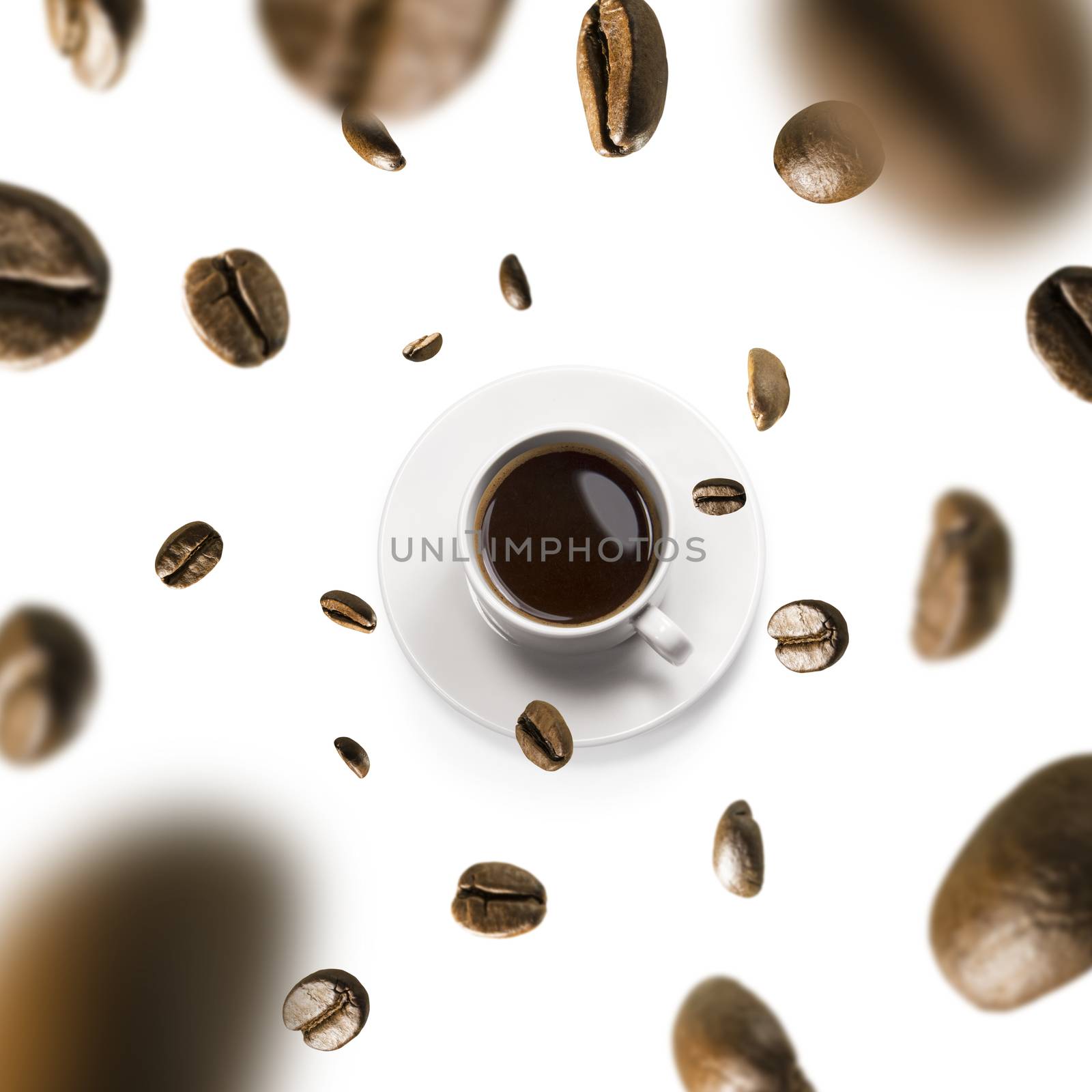 Cup of coffee and coffee beans in flight on white background.