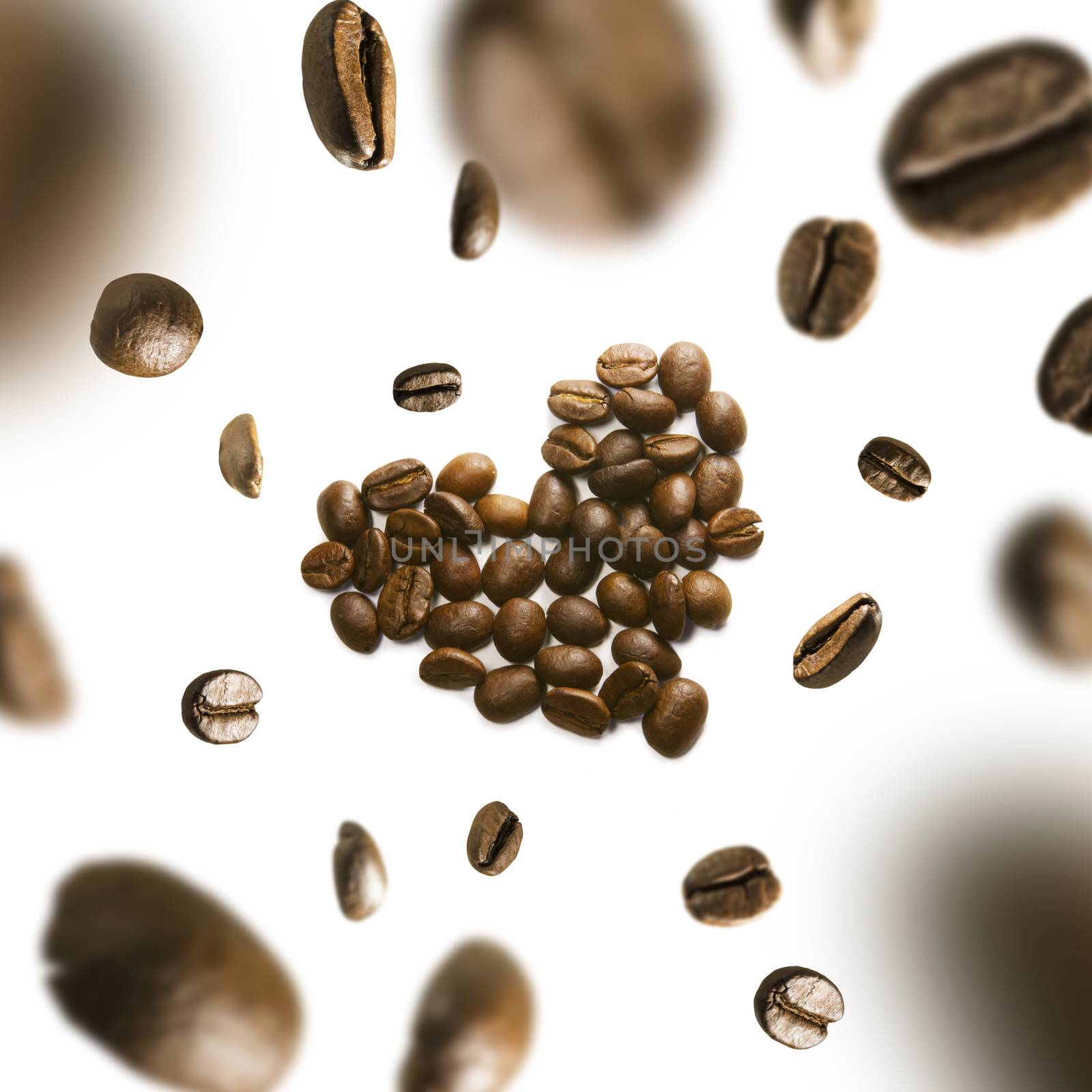 Coffee beans in the shape of a heart in flight on a white background,