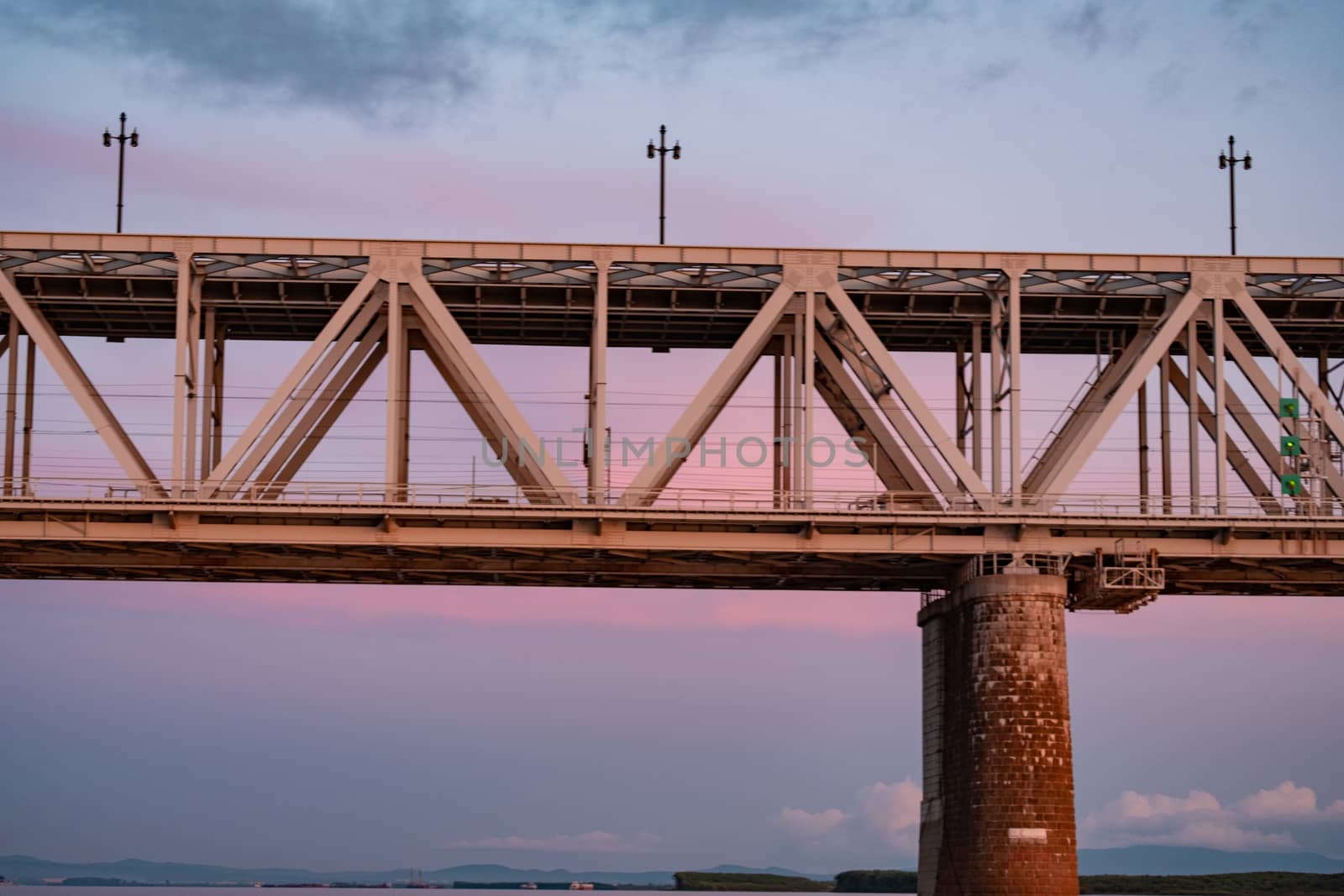 Bridge over the Amur river at sunset. Russia. Khabarovsk. Photo from the middle of the river. by rdv27