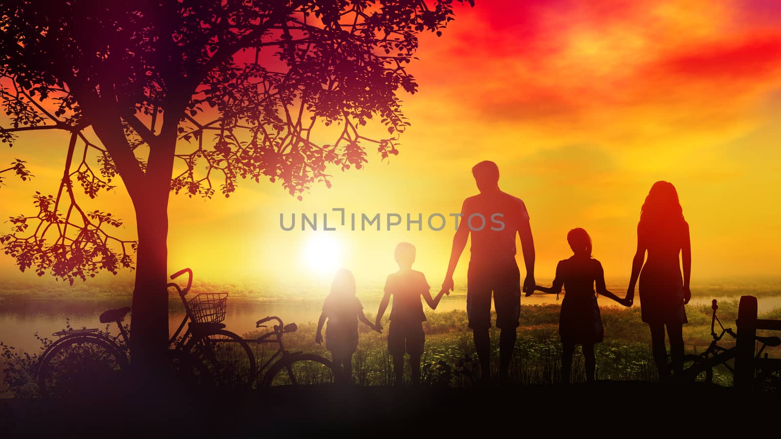 Against the background of a hot summer sunset, there are silhouettes of a family of five and bicycles lie nearby.