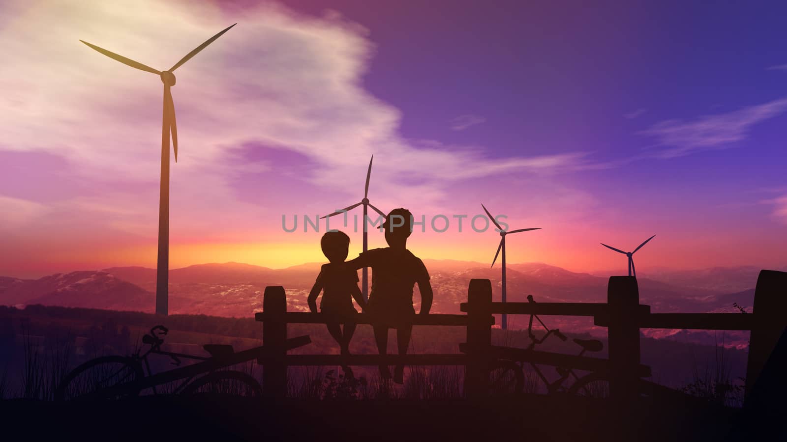 Children sitting on the fence and watching the wind power plants work against the sunset sky.