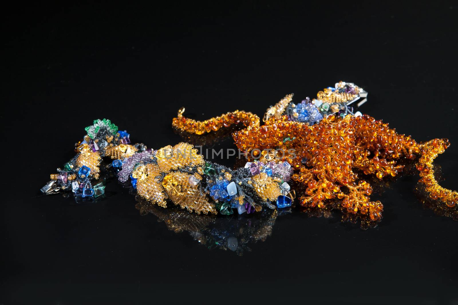 Different jewelries on a glass studio background