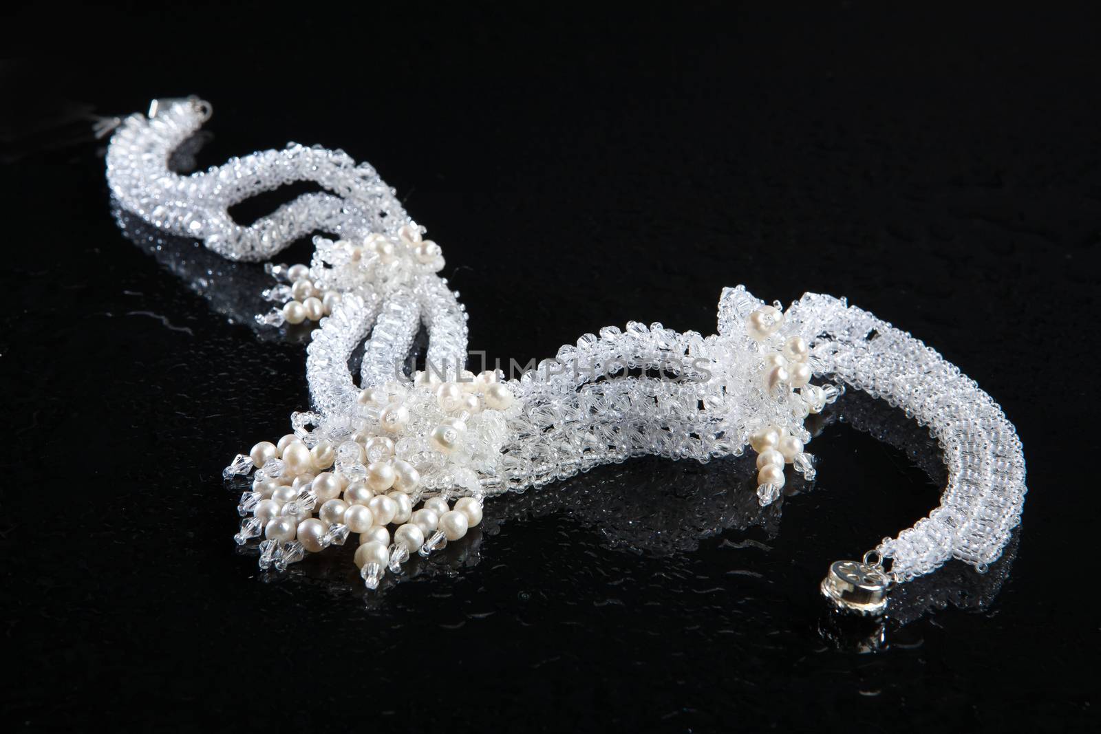Different jewelries on a glass studio background