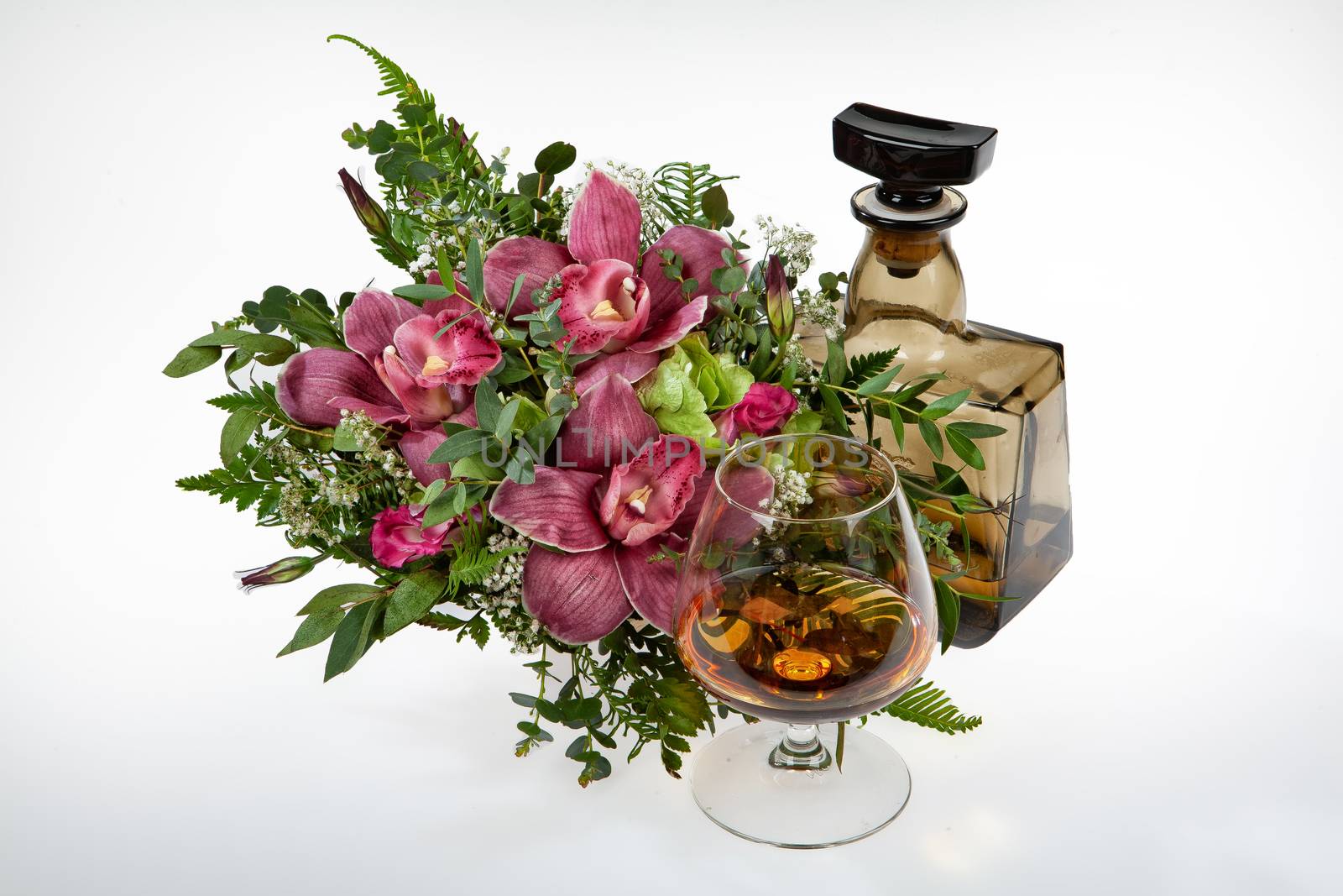 Bouquet of flowers and a bottle on a fabric background