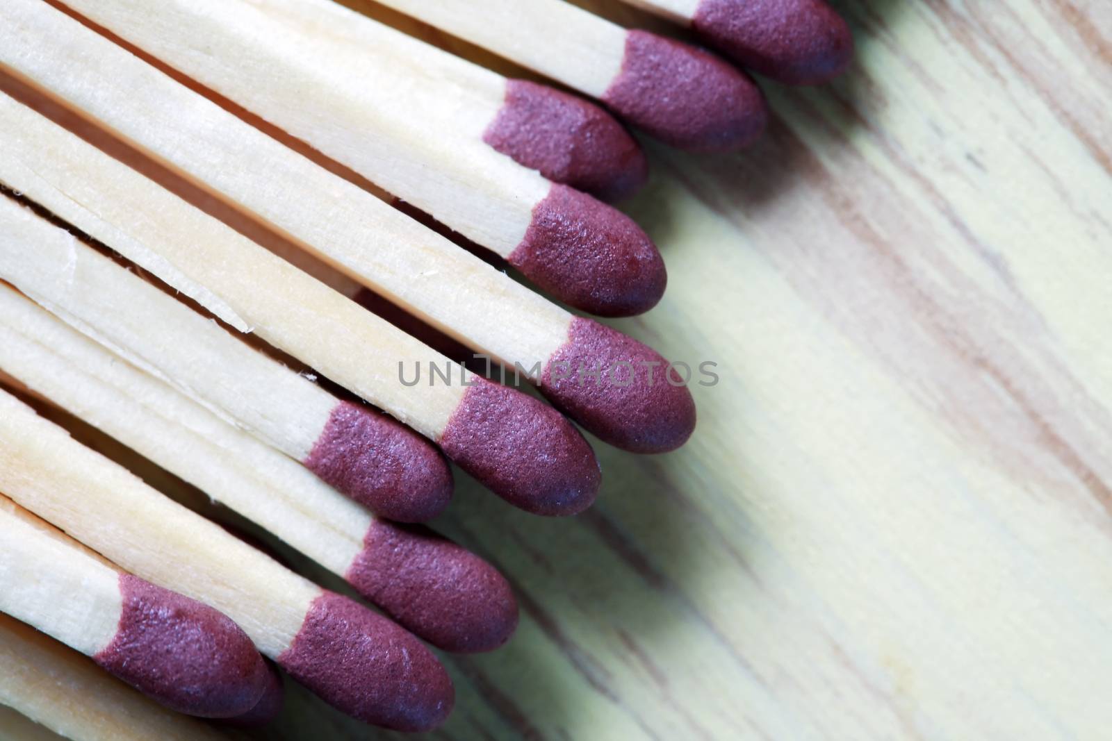 Extreme closeup of matchsticks on wooden background