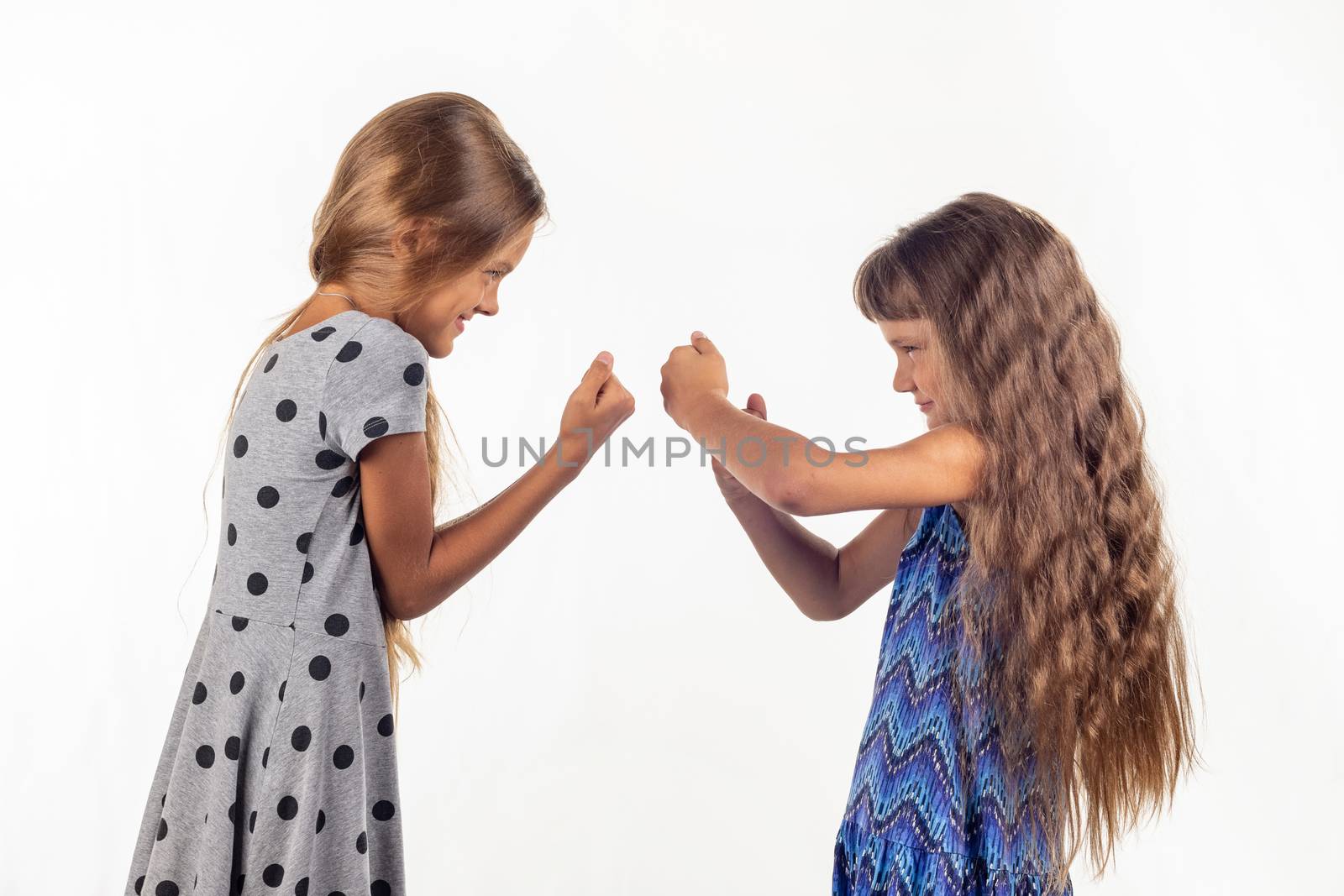 Two girls are fighting, studio white background