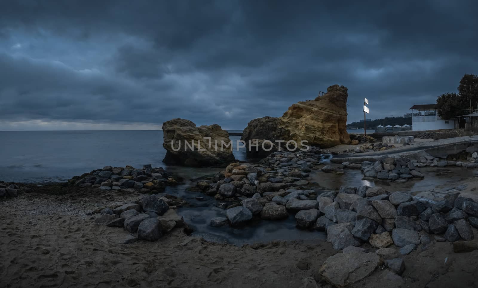 Dark and gloomy clouds asperatus over the sea until dawn.