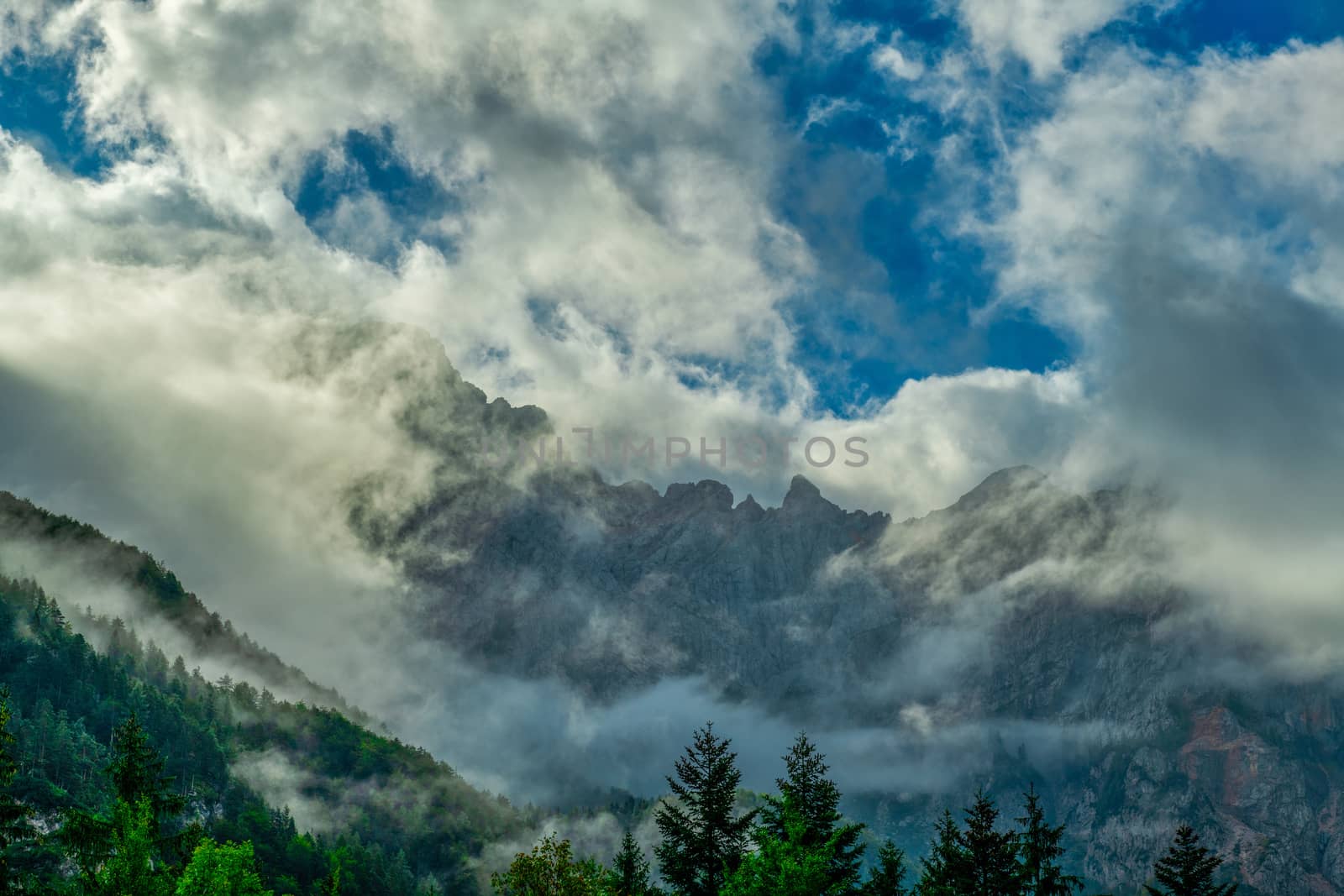 Dramatic clouds in front of mountain, outdoor activity, hiking, and travel, Ojstrica mountain view from Logarska dolina, Slovenia