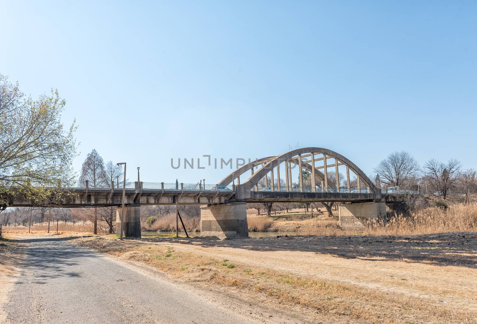 A street scene, with the Sarel Cilliers Bridge over the Vals River, in Kroonstad, a town in the Free State Province of South Africa