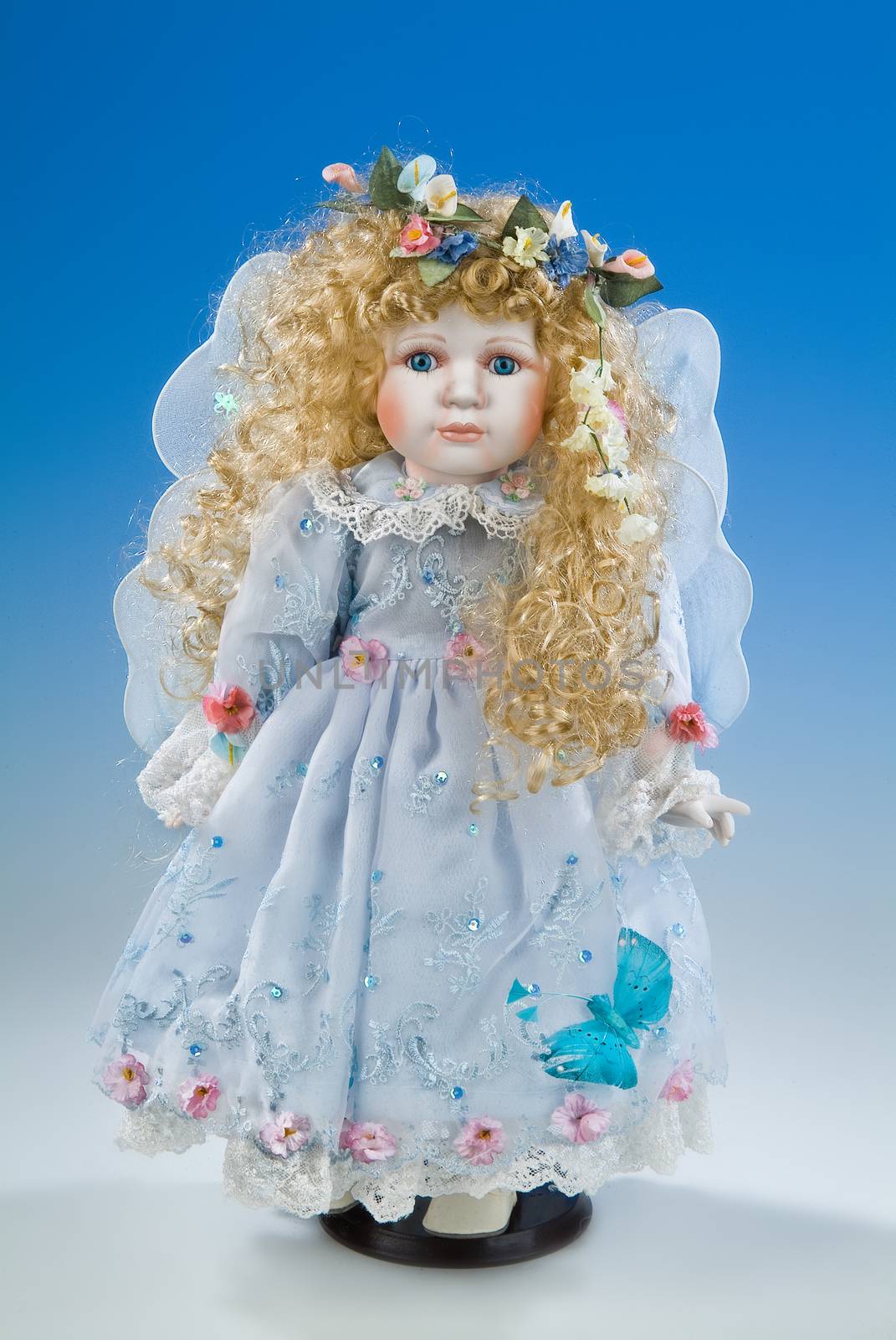 Big doll dressed in retro style on a blue and white background