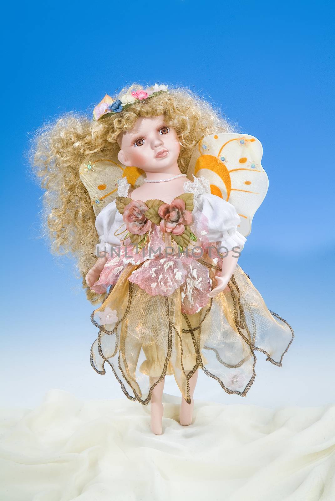 Big doll dressed in retro style on a blue and white background