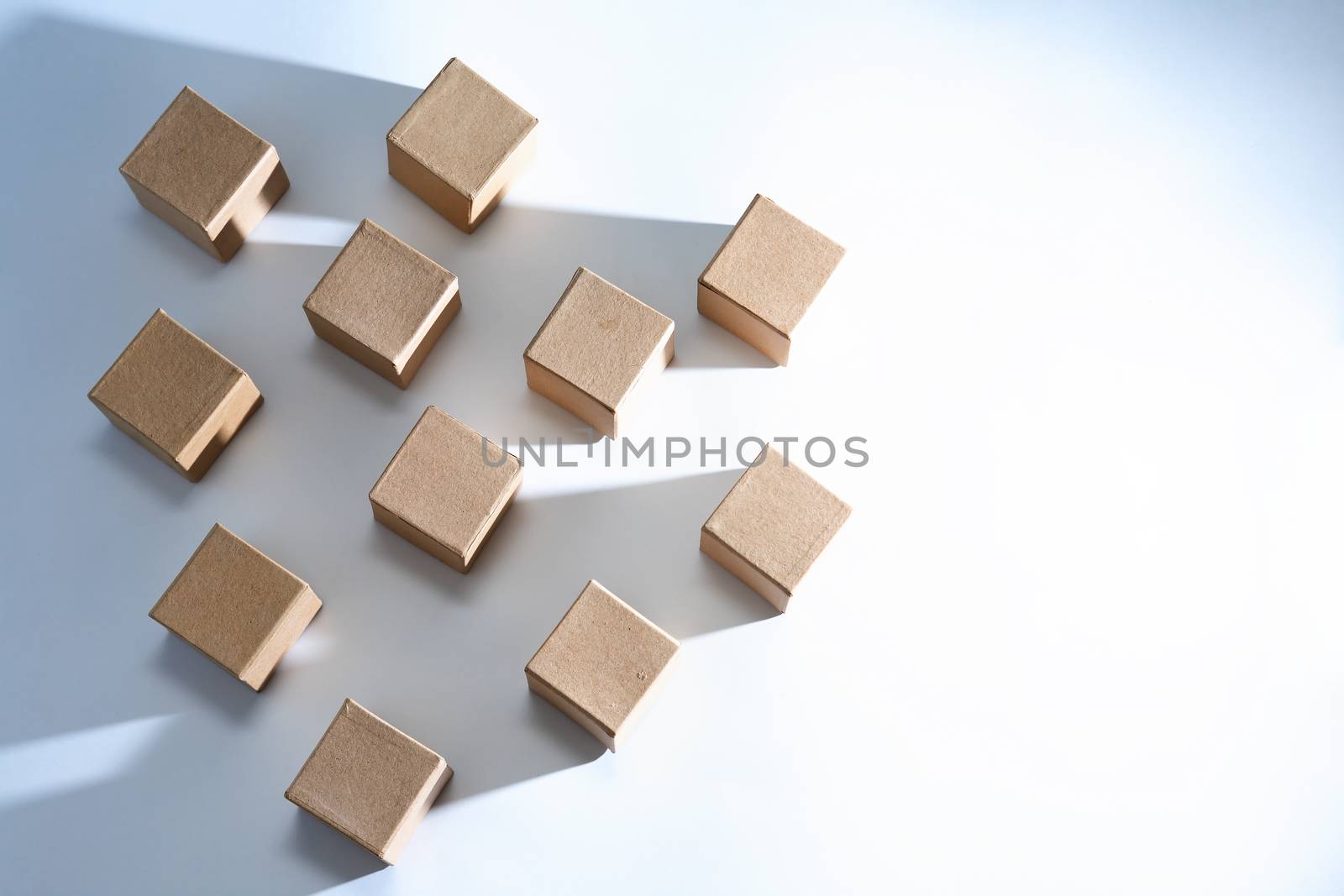 Set of cardboard cubes on white background with light and shadows