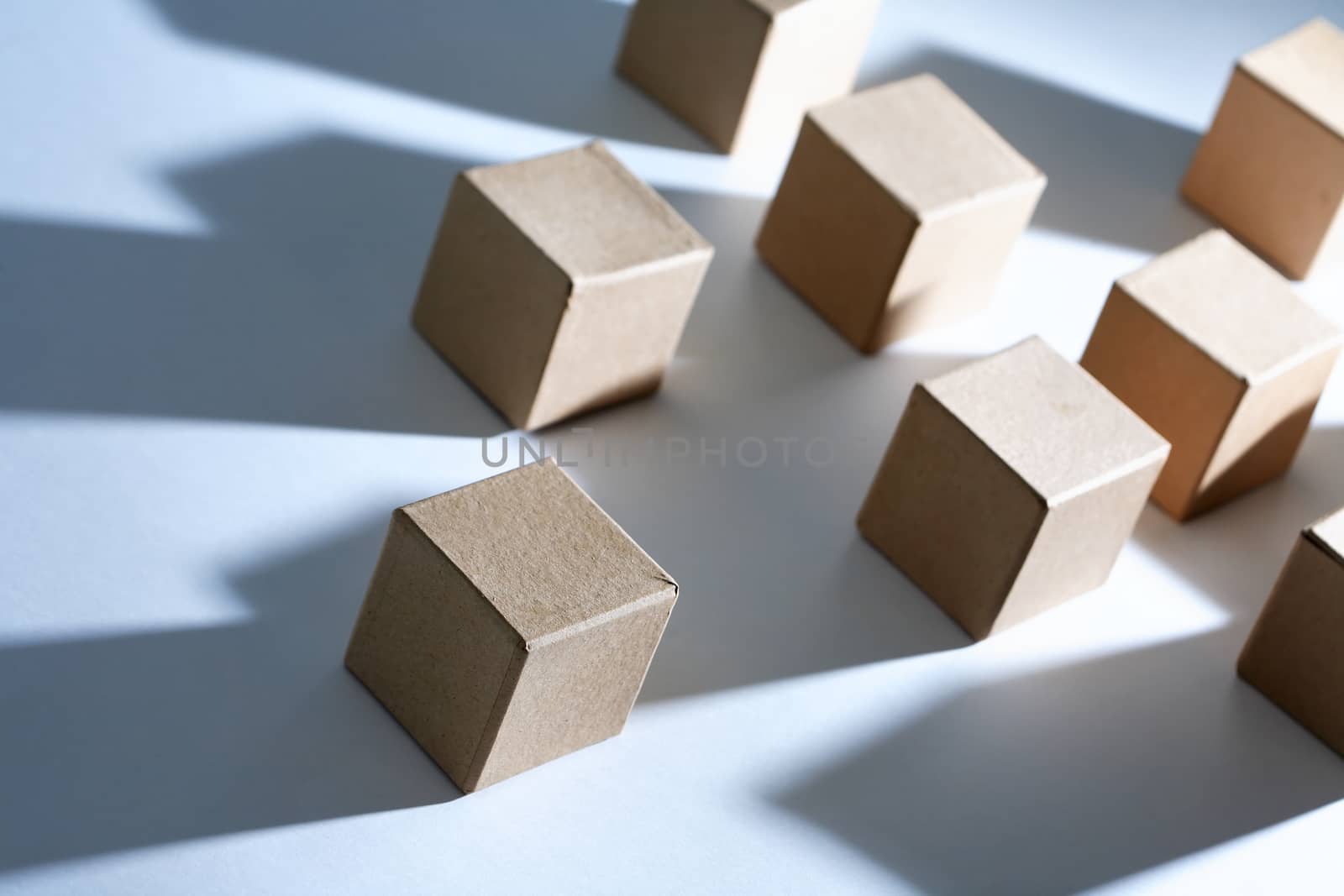 Set of cardboard cubes on white background with light and shadows