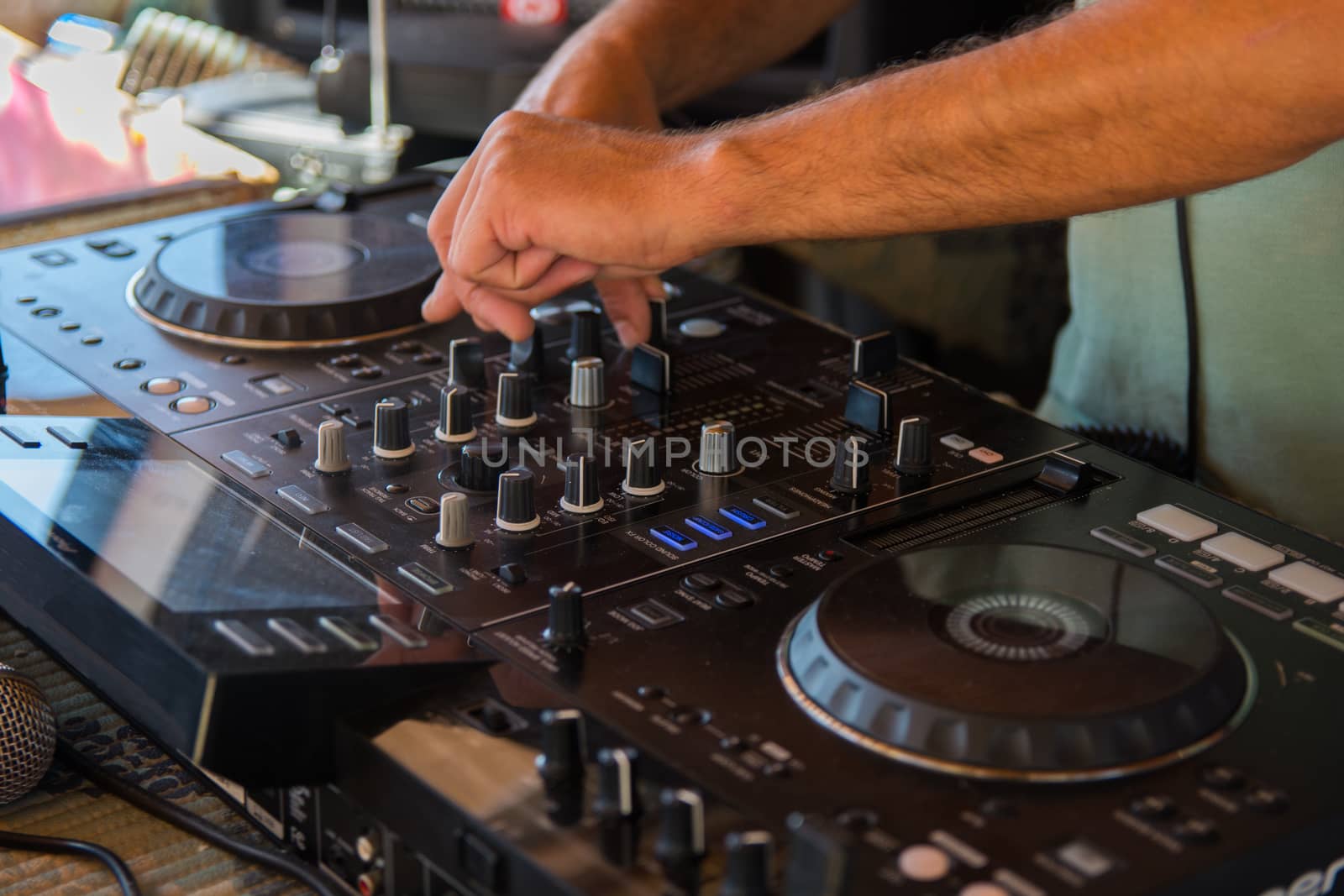 Party Dj play music at hip hop party.Turntable vinyl record player,analog audio equipment for disc jockey to scratch vinyl records,mix tracks.DJ scratching record,cut with cross fader.Dj party in club