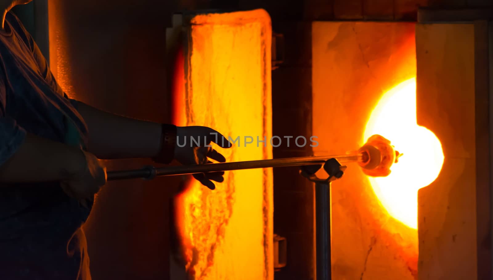 shaping in glass oven. very hot, glass melting