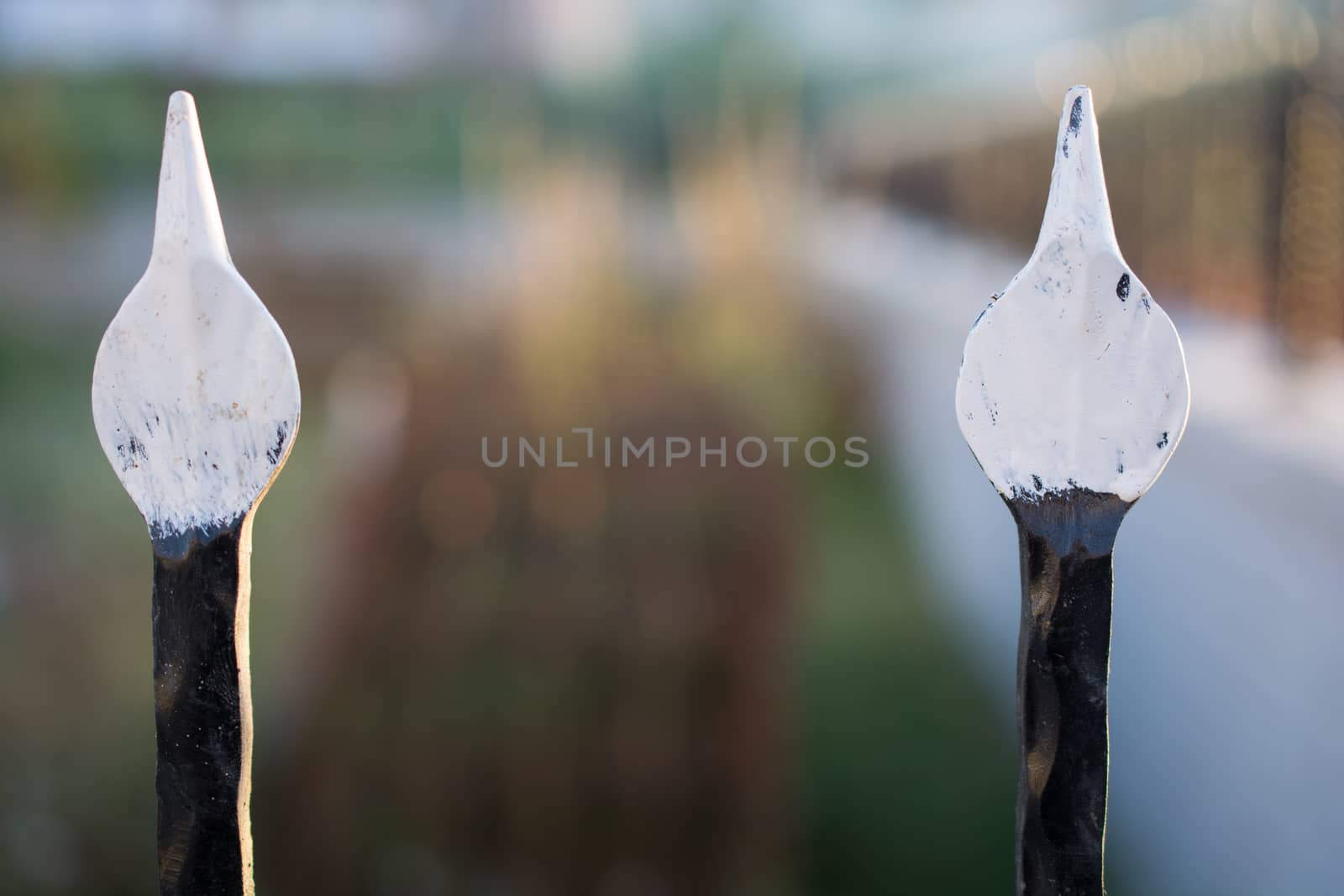 wrought iron pointed iron tips. the ends are painted white