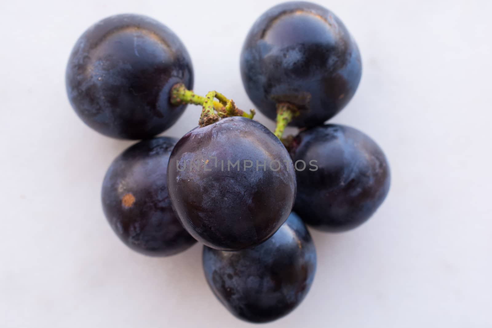 black colored, coarse, wine material. sweet, juicy seed grape