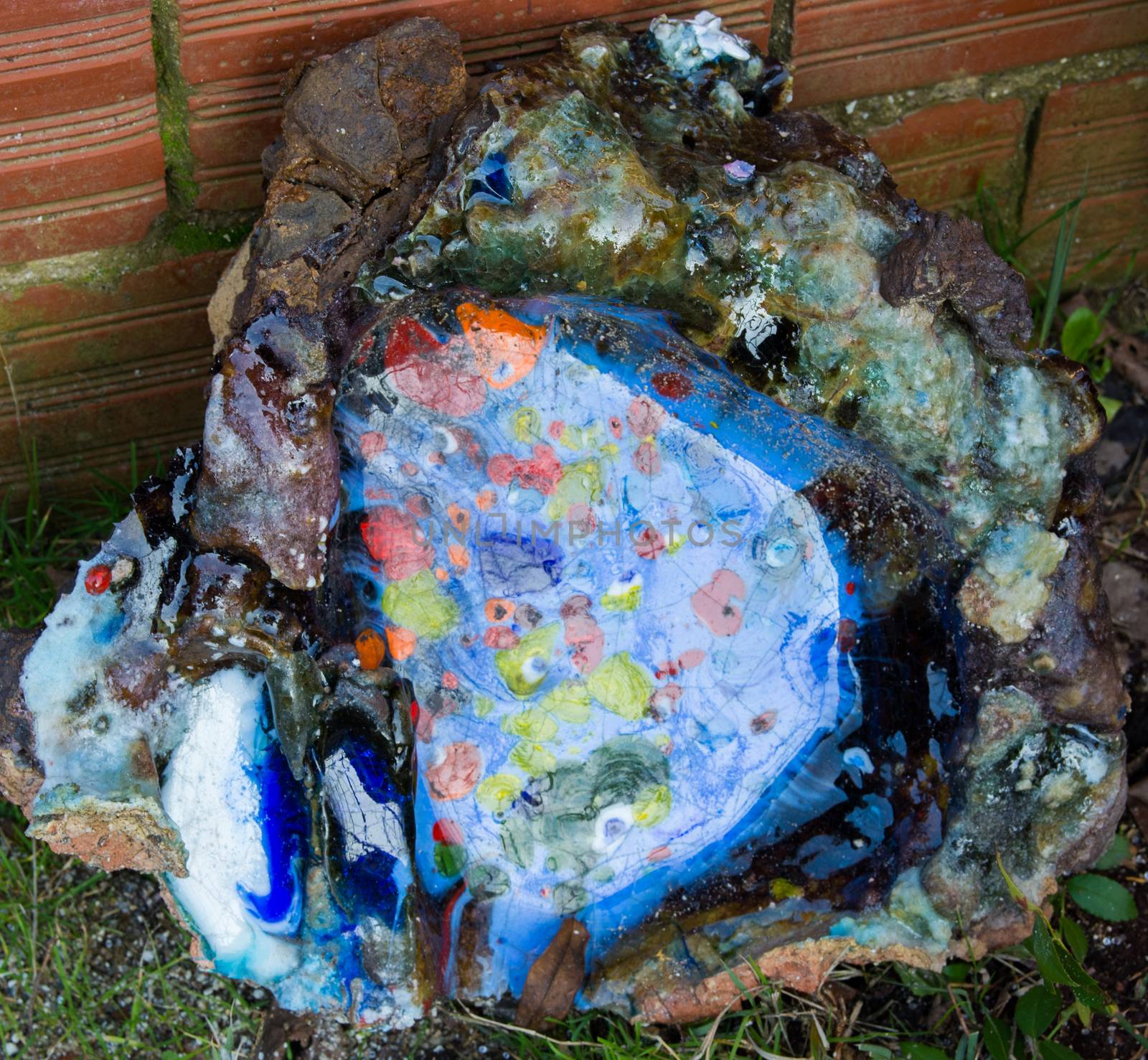 oven melting furnace used in making evil eye beads. over time the remaining residues from the beads stick to the oven pan. a colored mold is formed