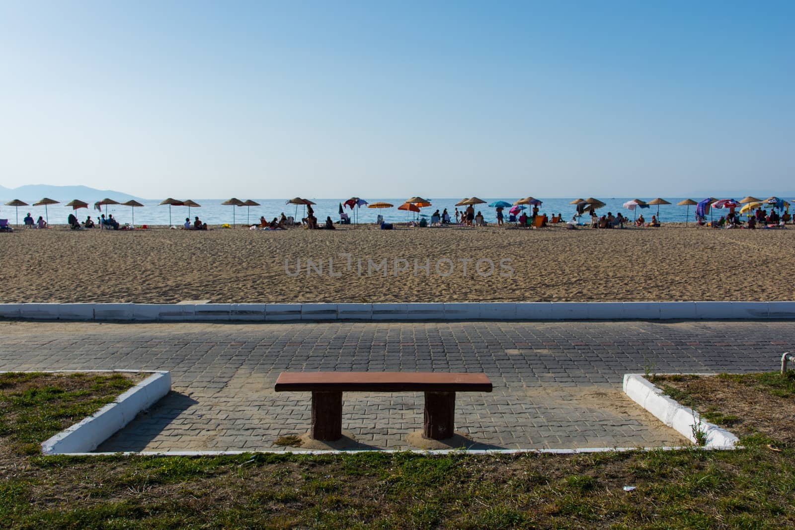 an empty seat on the crowded beach