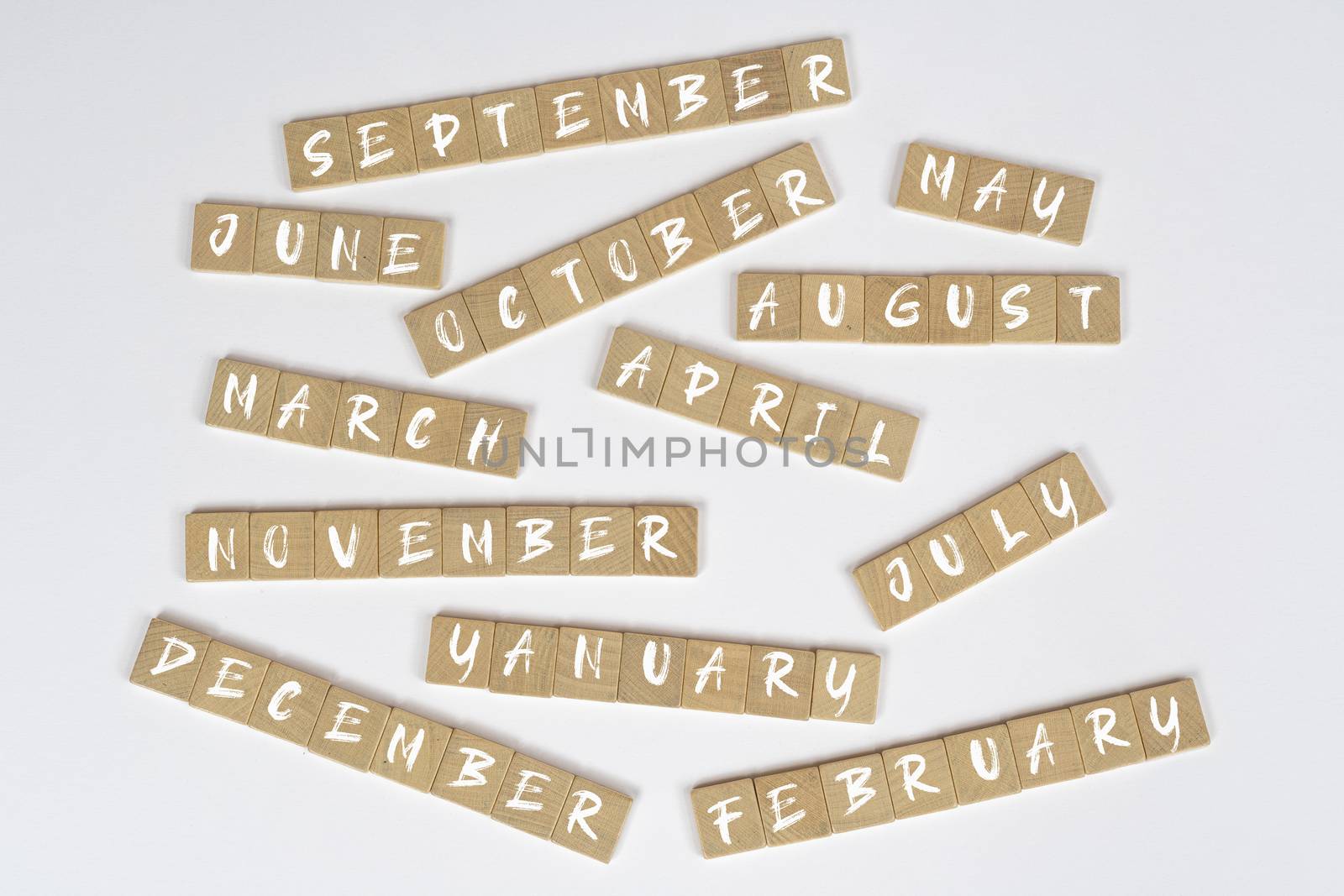 the months of the year written on wooden tiles