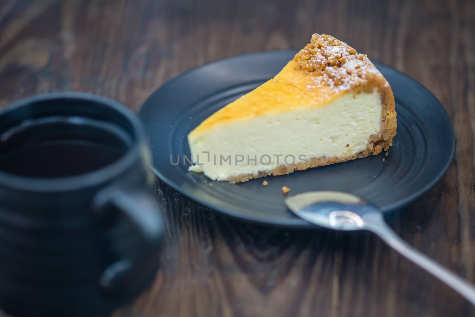 Cheesecake on black plate and coffee