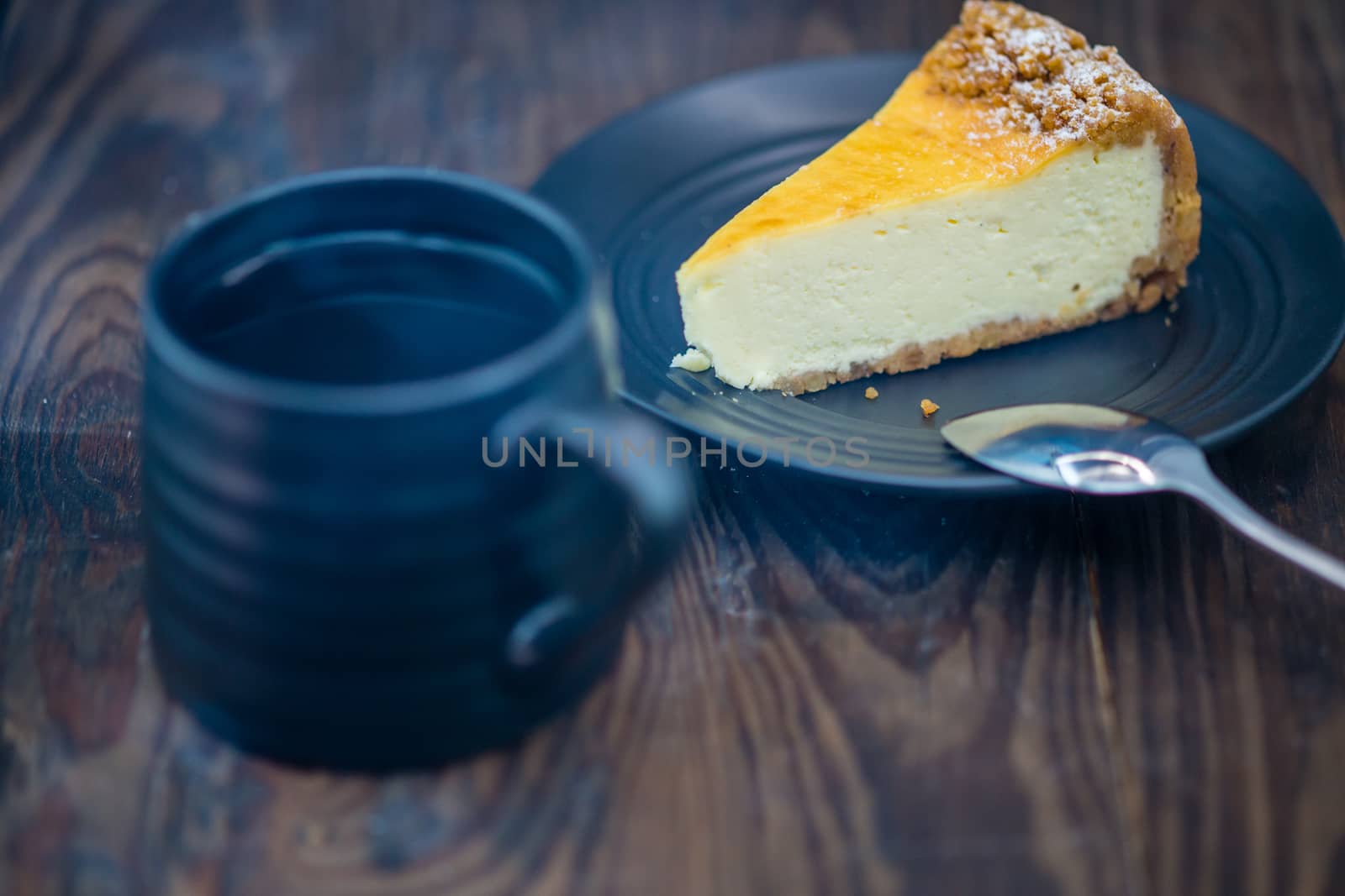 Cheesecake on black plate and coffee