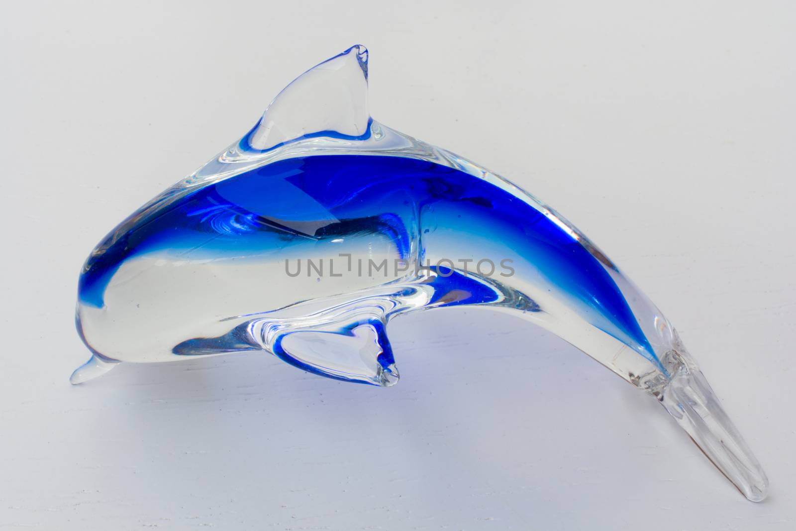 dolphin ornament made of glass. in-glass blue painted