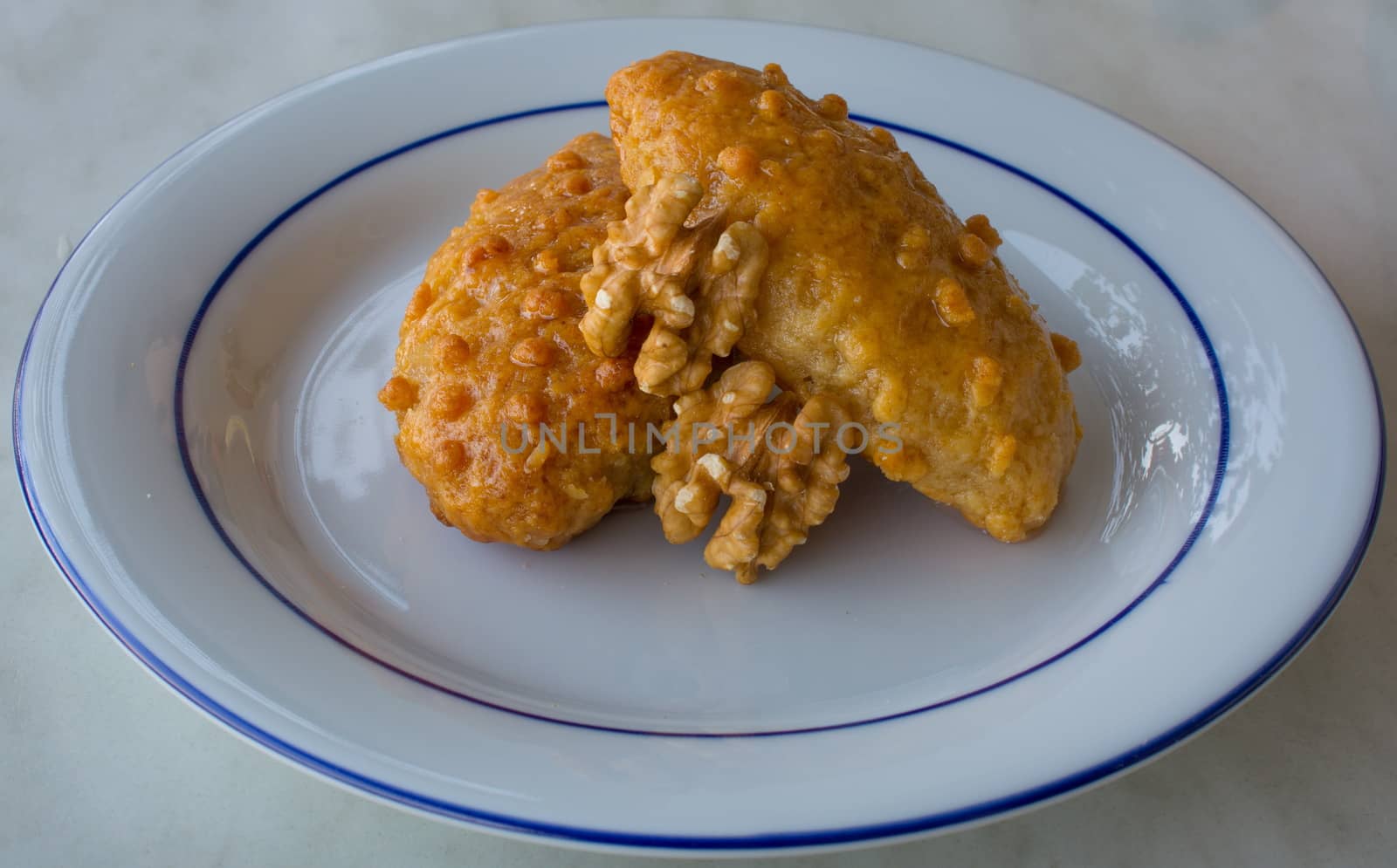 "kalburabastı" dessert;sherbet turkish sweet. For the dough, margarine, flour, yoghurt, oil, eggs, baking soda, walnuts are used. the colander is shaped by pressing