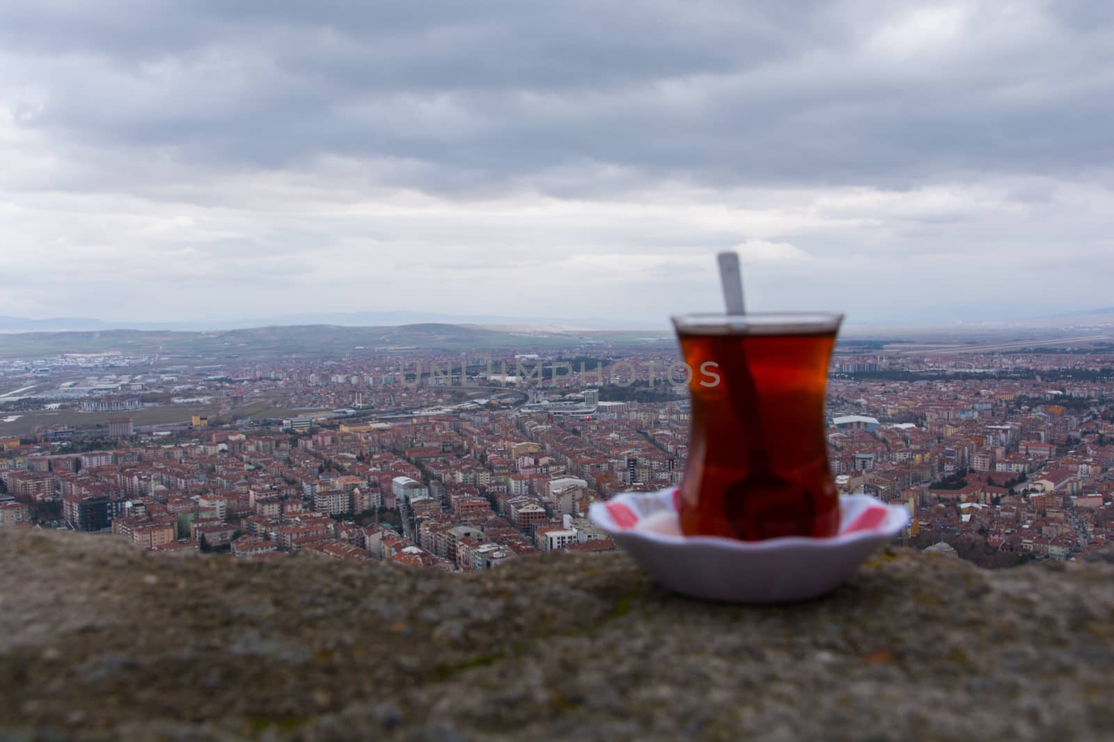 tea enjoyment. enjoying a hot tea while watching the city view from the top