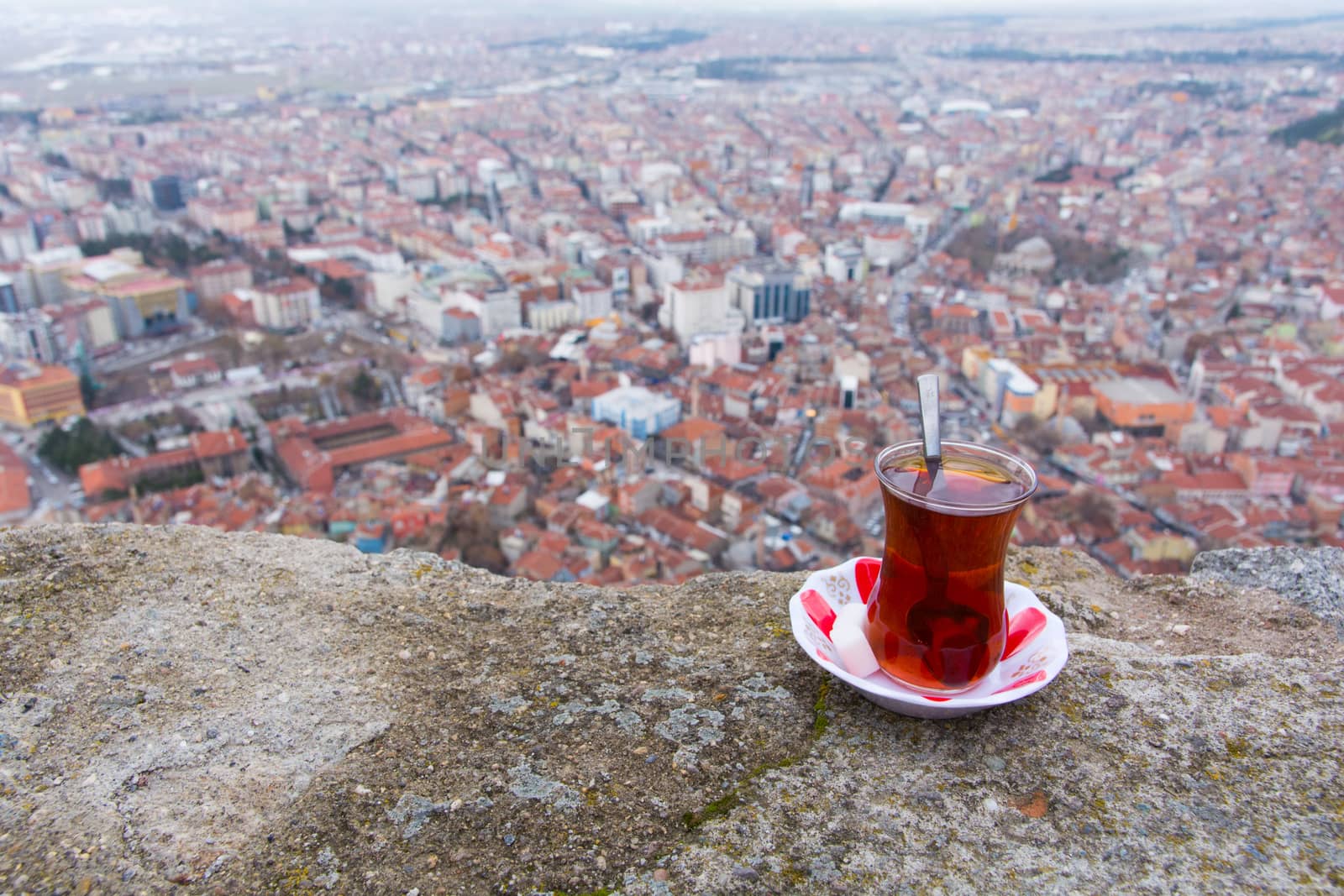 tea enjoyment. enjoying a hot tea while watching the city view from the top