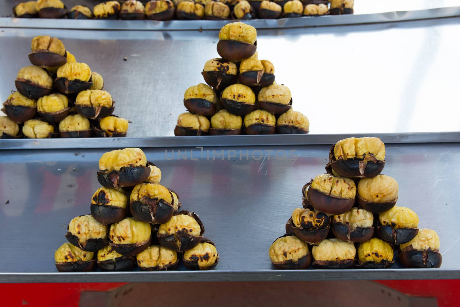 Grilled chestnuts for sale on street.cooked on barbecue. plenty of Christmas and winter are consumed