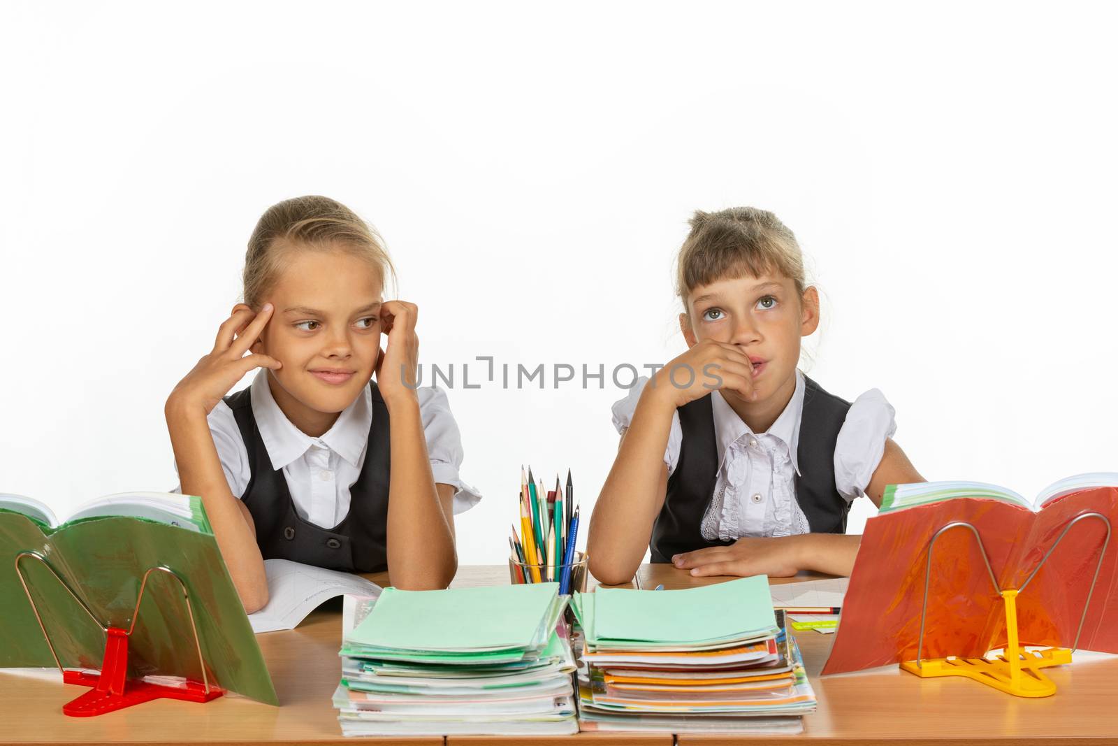 Two girls thought about an abstract topic while sitting at a desk at school
