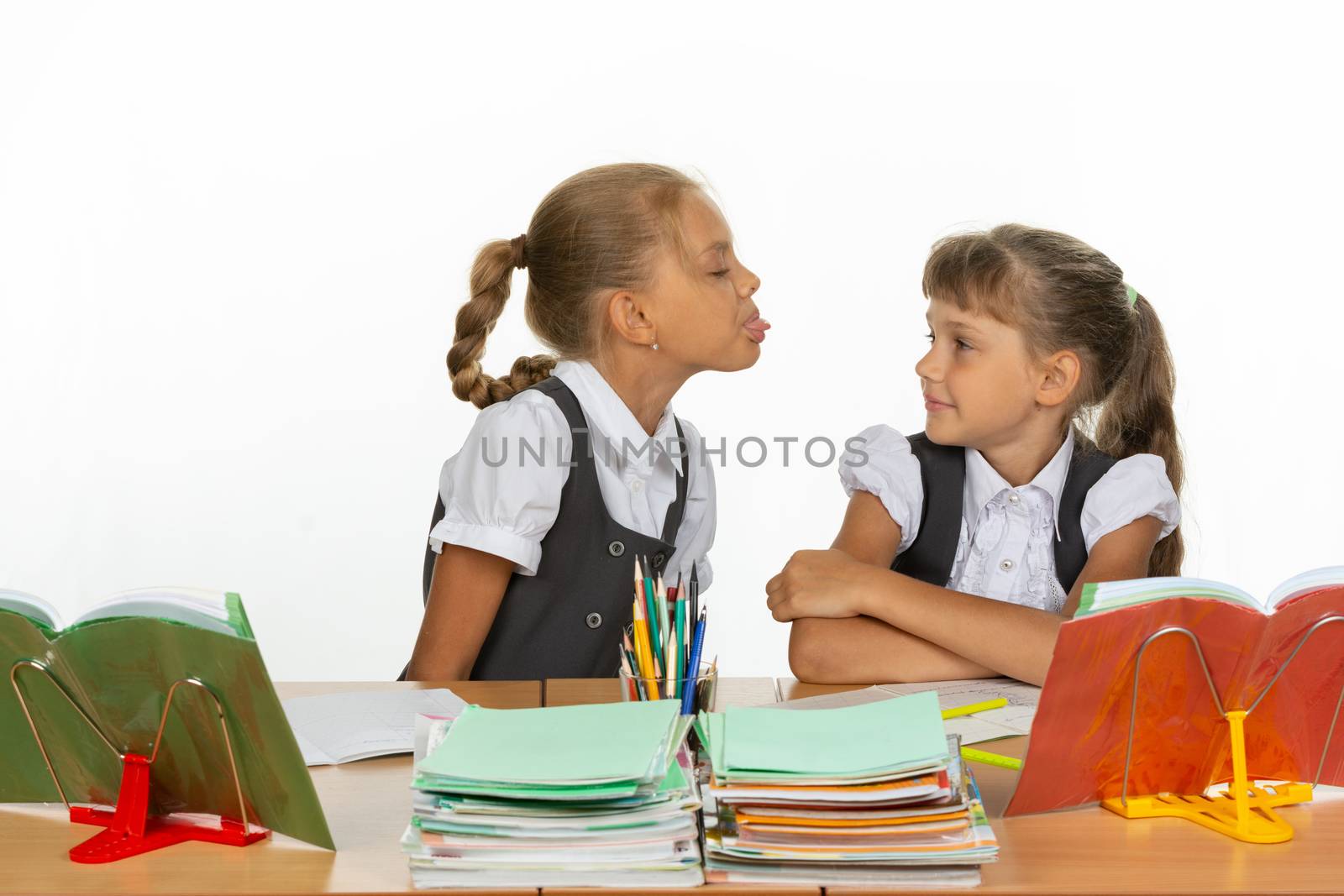 Girl at her desk showed tongue to another girl