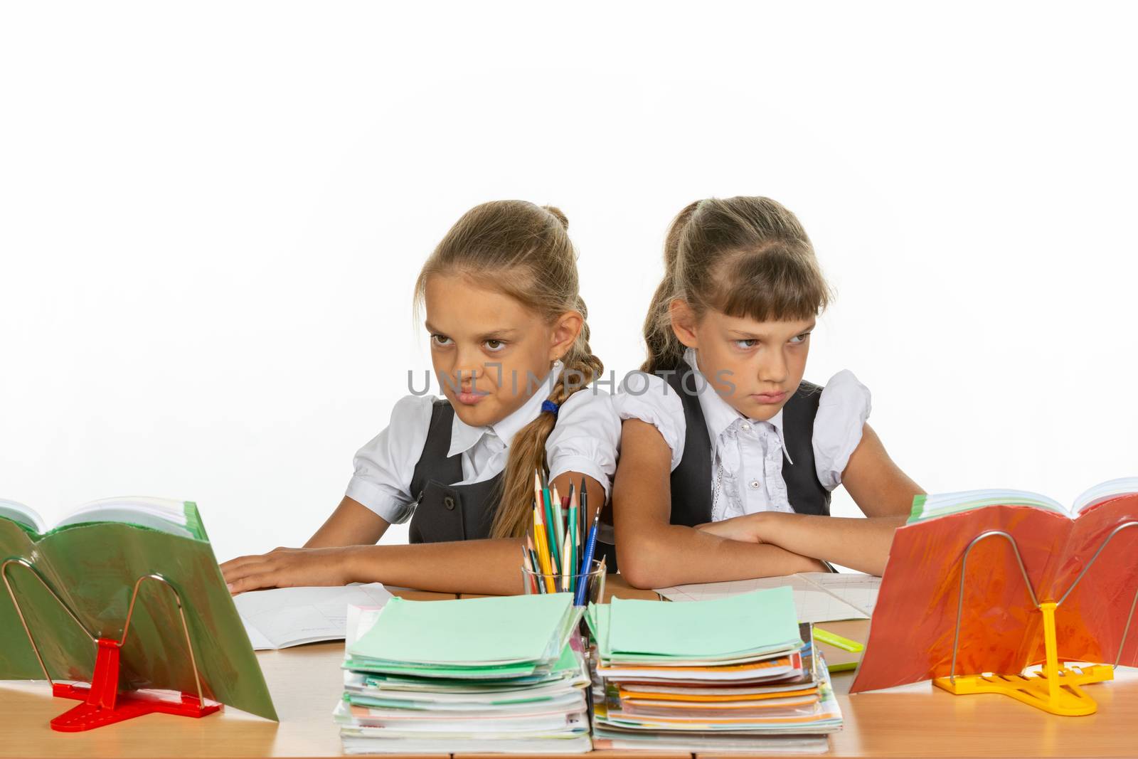 Two quarreling girls at the same desk