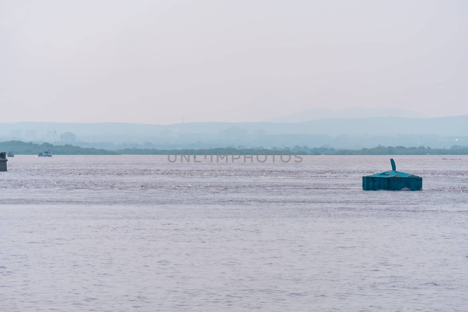 Khabarovsk, Russia - Aug 08, 2019: Flood on the Amur river near the city of Khabarovsk. The level of the Amur river at around 159 centimeters. by rdv27